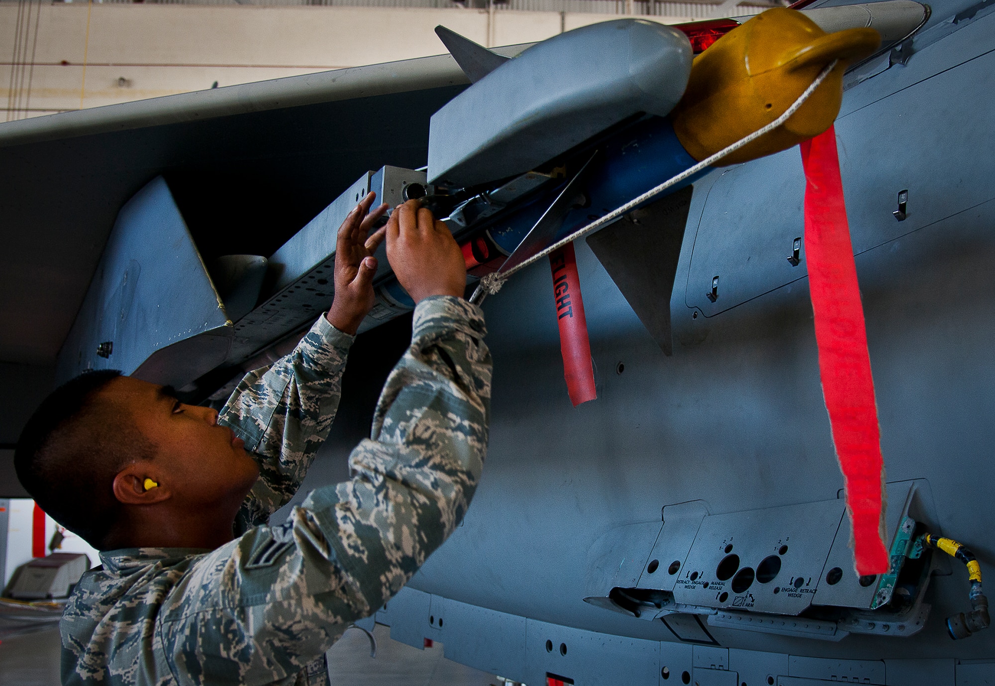 Airman 1st Class Marqwilliam Aguilar, of the 96th Aircraft Maintenance Squadron Red, checks the connections on an AIM-9 to his F-15 during the 96th Maintenance Group’s quarterly weapons loadcrew competition Sept. 20 at Eglin Air Force Base, Fla. The Red Team of Staff Sgt. Derek Cook, Aguilar and Senior Airman Mark Timpani won the competition.  (U.S. Air Force photo/Samuel King Jr.)