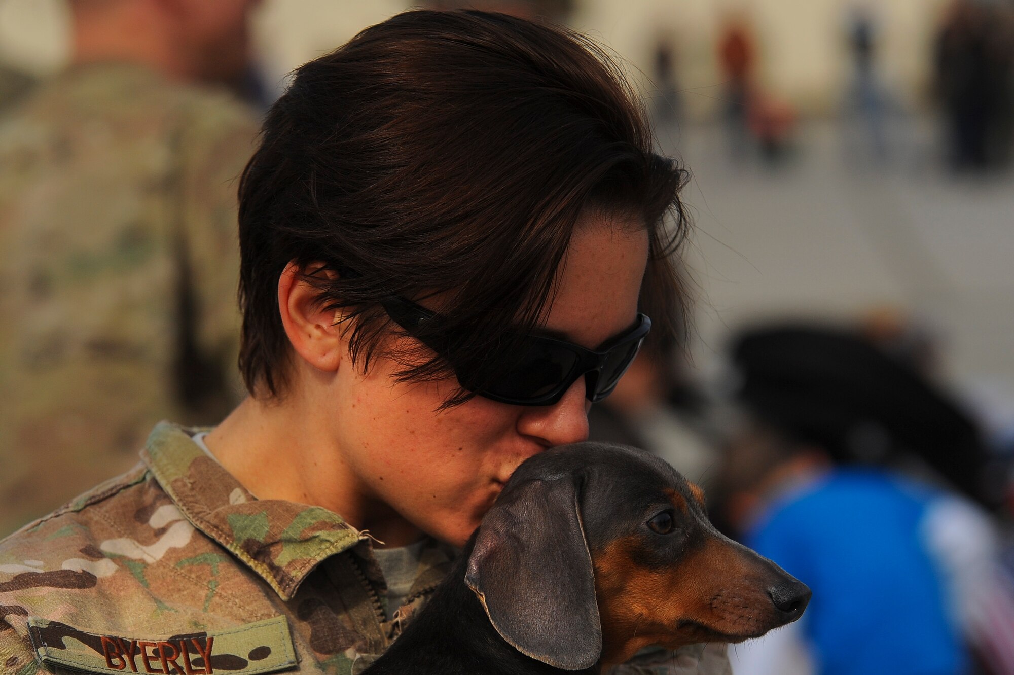 SPANGDAHLEM AIR BASE, Germany---Staff Sgt. Beriah Byerly, a 52nd Equipment Maintenance Squadron munitions systems crew chief, kisses her dog Lola after returning home from a deployment Sept. 21, 2013. Byerly was one of more than 185 Airmen that support combat operations in Southwest Asia. (U.S. Air Force photo by Senior Airman Rusty Frank/Released)