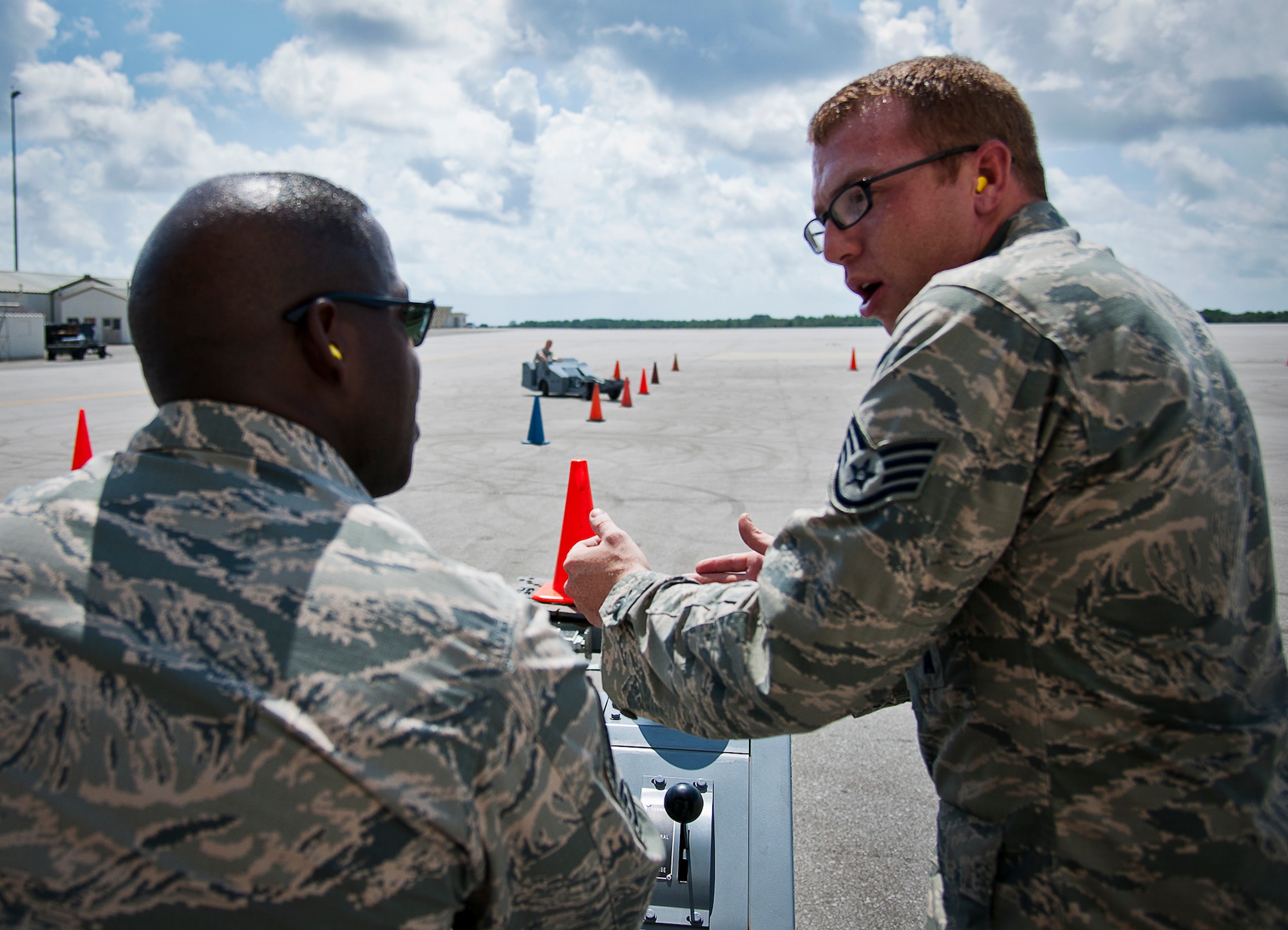 Chief Master Sgt. Marcus Snoddy, the 96th Test Wing command chief, gets some last minute pointers from Staff Sgt. Jason Vermillion, of the 96th Maintenance Group, before he takes to the course during the commanders and chiefs jammer race at Eglin Air Force Base, Fla., Sept. 20.  The wing and group commanders and chiefs of the 96th Test Wing drove the jammer through a timed obstacle course to see who could maneuver the quick-turning weapons loader through a series of cones the fastest and with the fewest errors.  The 96th Maintenance Group, who hosted the event, took home the inaugural trophy. (U.S. Air Force photo/Samuel King Jr.)