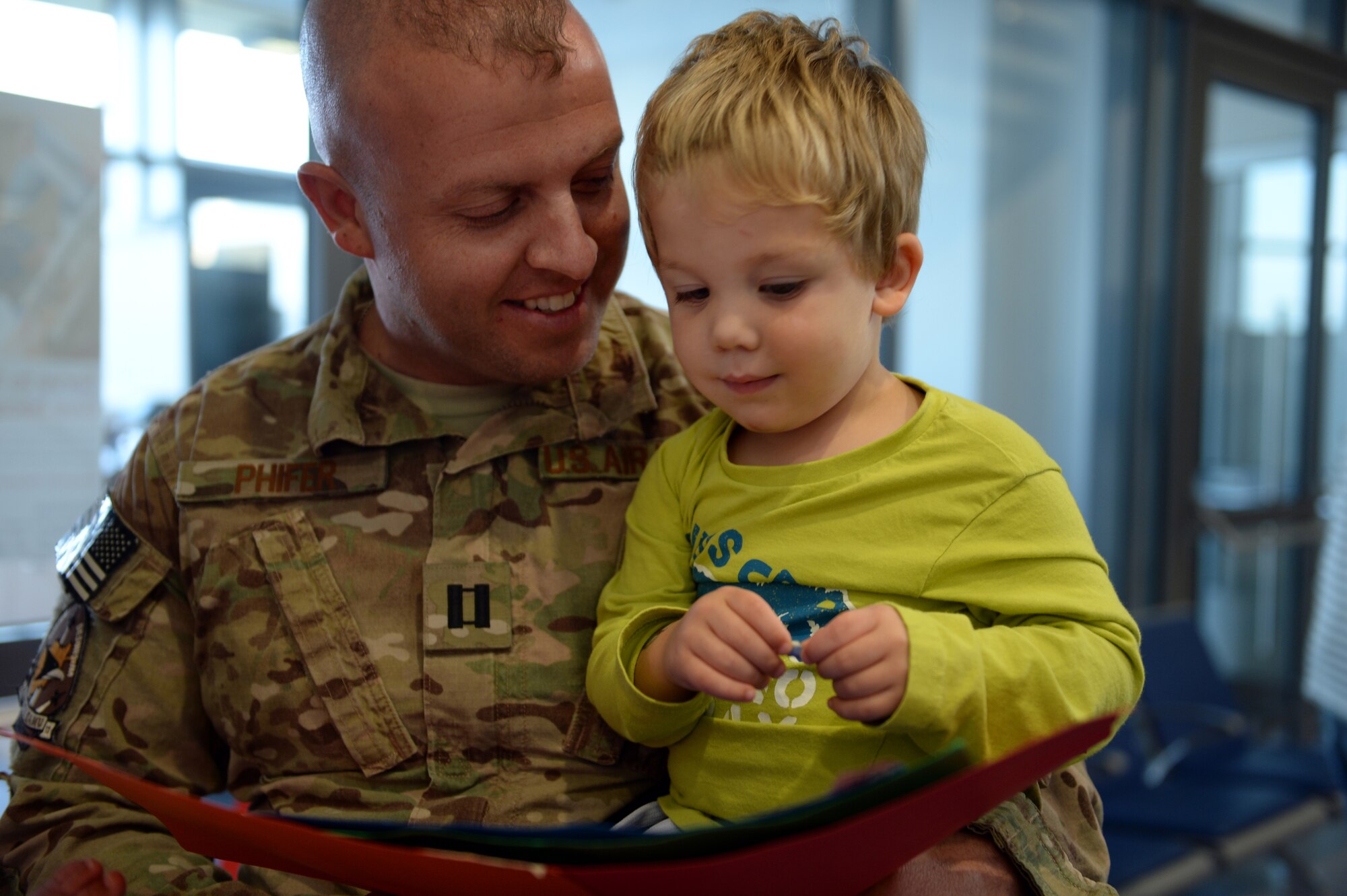 SPANGDAHLEM AIR BASE, Germany — U.S. Air Force Capt. Jeremy Phifer, 480th Aircraft Maintenance Unit officer in charge, holds his 2-year-old son Simon Sept. 21, 2013, after returning from a six-month deployment to support combat operations in Southwest Asia. The 480th Fighter Squadron support community  comprises  nearly 250 Airmen hailing from five maintenance career fields. (U.S. Air Force photo by Senior Airman Alexis Siekert/Released)