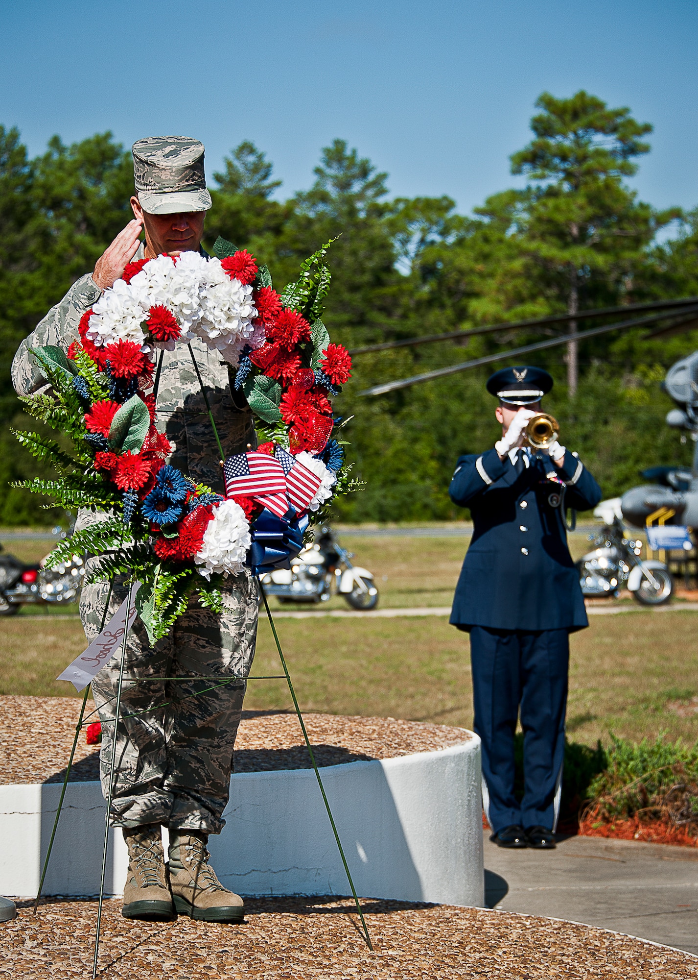 A lone Airman salutes during the playing of Taps at Eglin’s POW/MIA remembrance ceremony Sept. 20 at the Air Force Armament Museum.  The ceremony paid tribute to those military members who have yet to return home from defending America. The event featured tributes, guest speakers and honor guard procedures. (U.S. Air Force photo/Tech. Sgt. Jasmin Taylor)