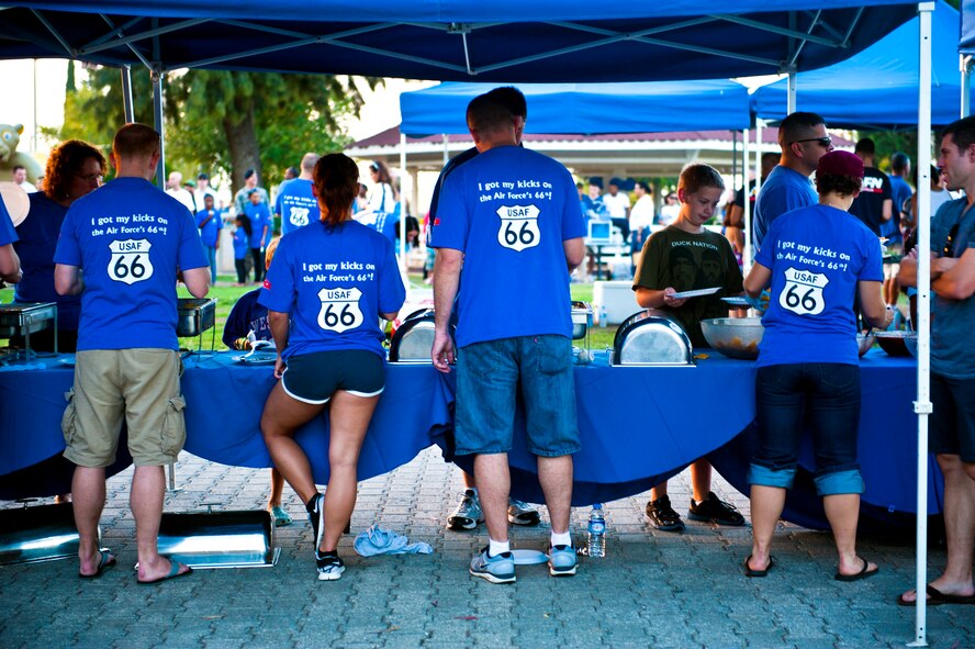 Team Incirlik members serve food during the Air Force Birthday Party Bash at Arkadas Park Sept. 20, 2013, at Incirlik Air Base, Turkey. Each year, Air Force installations around- the-world celebrate the birth of the Air Force during the month of September. (U.S. Air Force photo by Senior Airman Daniel Phelps/Released)