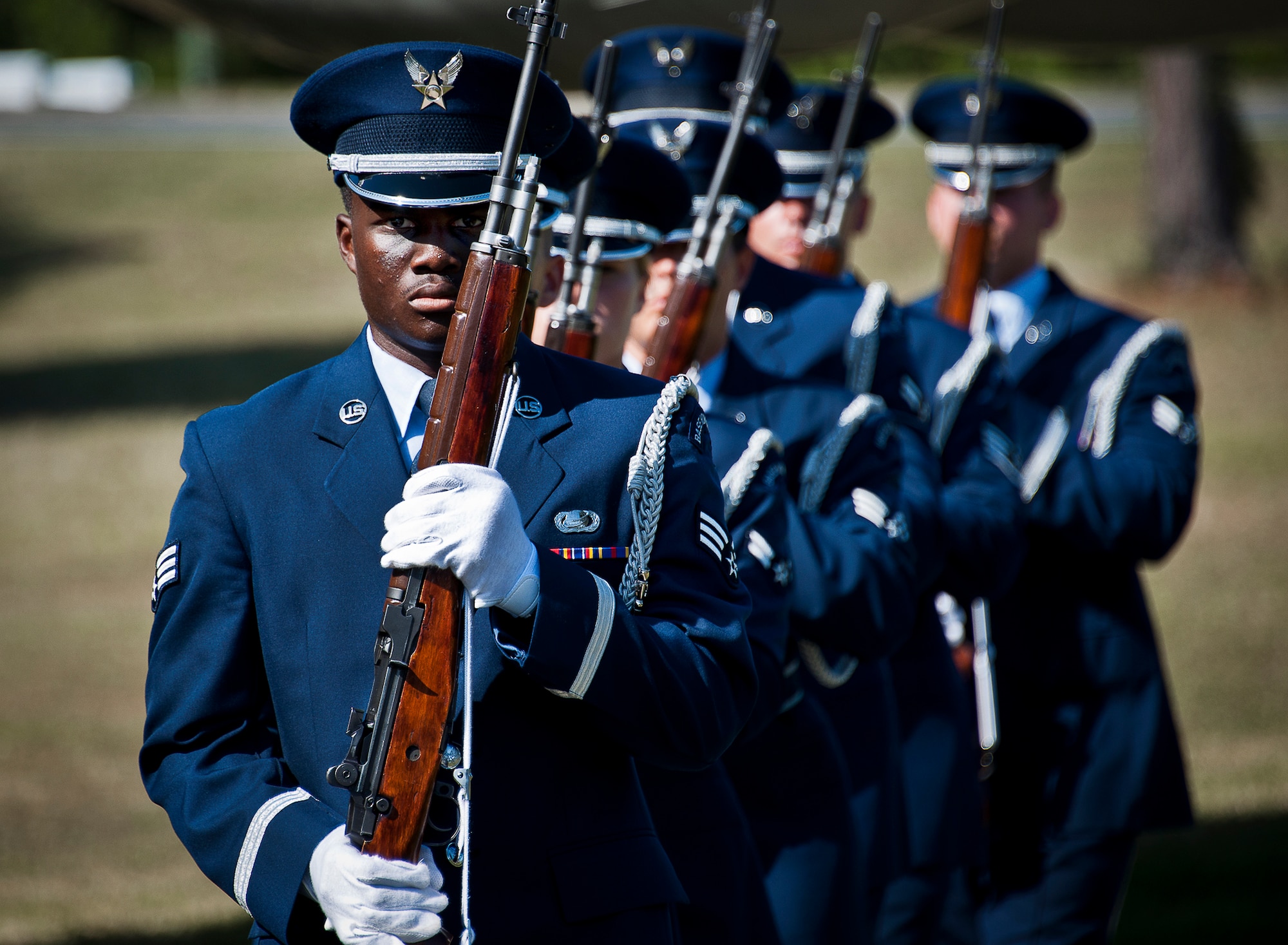 Senior Airman Richard King leads the Team Eglin honor guard rifle volley team away after Eglin’s POW/MIA remembrance ceremony Sept. 20 at the Air Force Armament Museum.  The ceremony paid tribute to those military members who have yet to return home from defending America. The event featured tributes, guest speakers and honor guard procedures. (U.S. Air Force photo/Samuel King Jr.)
