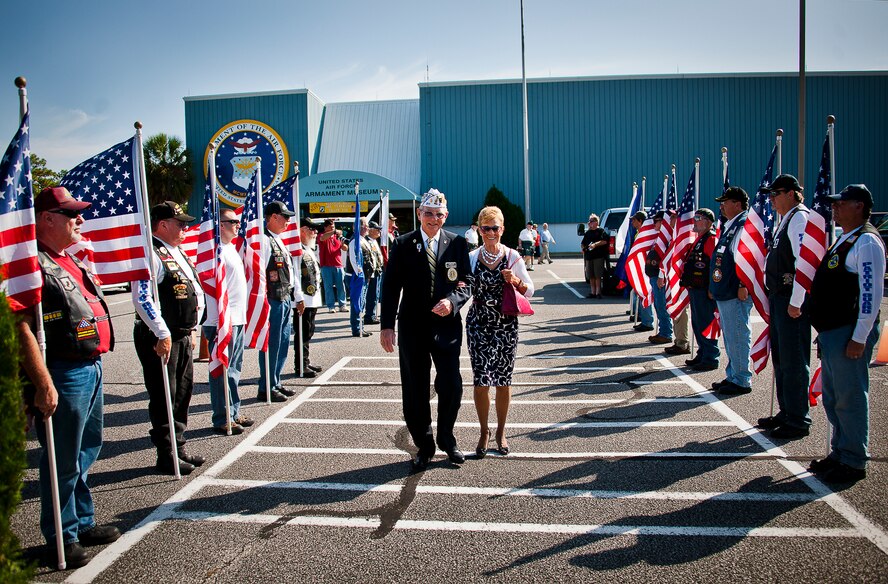 Special guests passed by the patriot guard with flags before finding their seats for the outside portion of the POW/MIA event Sept. 20 at the Air Force Armament Museum. The ceremony paid tribute to those military members who have yet to return home from defending America. The event featured tributes, guest speakers and honor guard procedures. (U.S. Air Force photo/Samuel King Jr.)