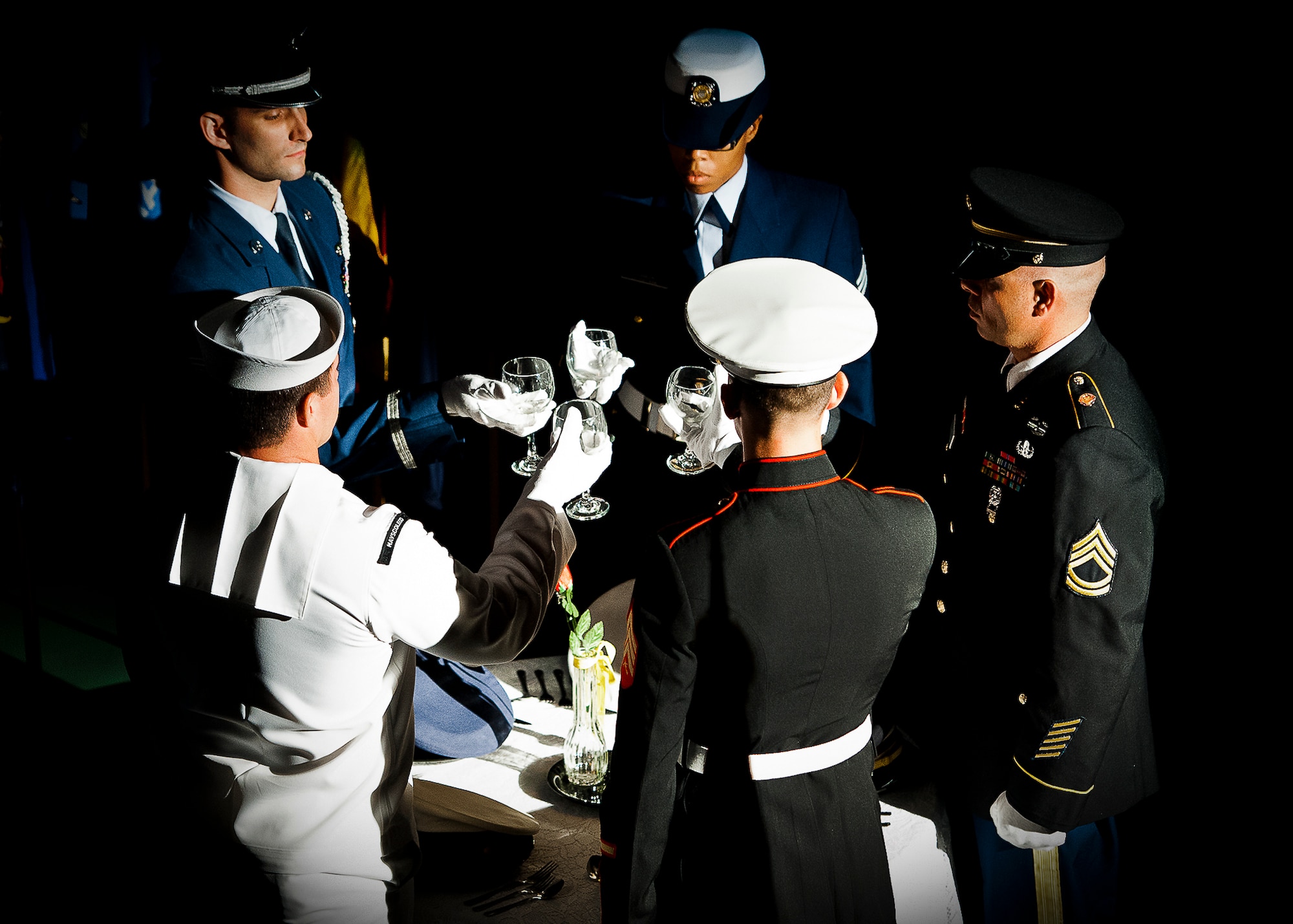 A joint service color guard sets the POW/MIA table during Eglin’s POW/MIA remembrance ceremony Sept. 20 at the Air Force Armament Museum.  The ceremony paid tribute to those military members who have yet to return home from defending America. The event featured tributes, guest speakers and honor guard procedures. (U.S. Air Force photo/Samuel King Jr.)