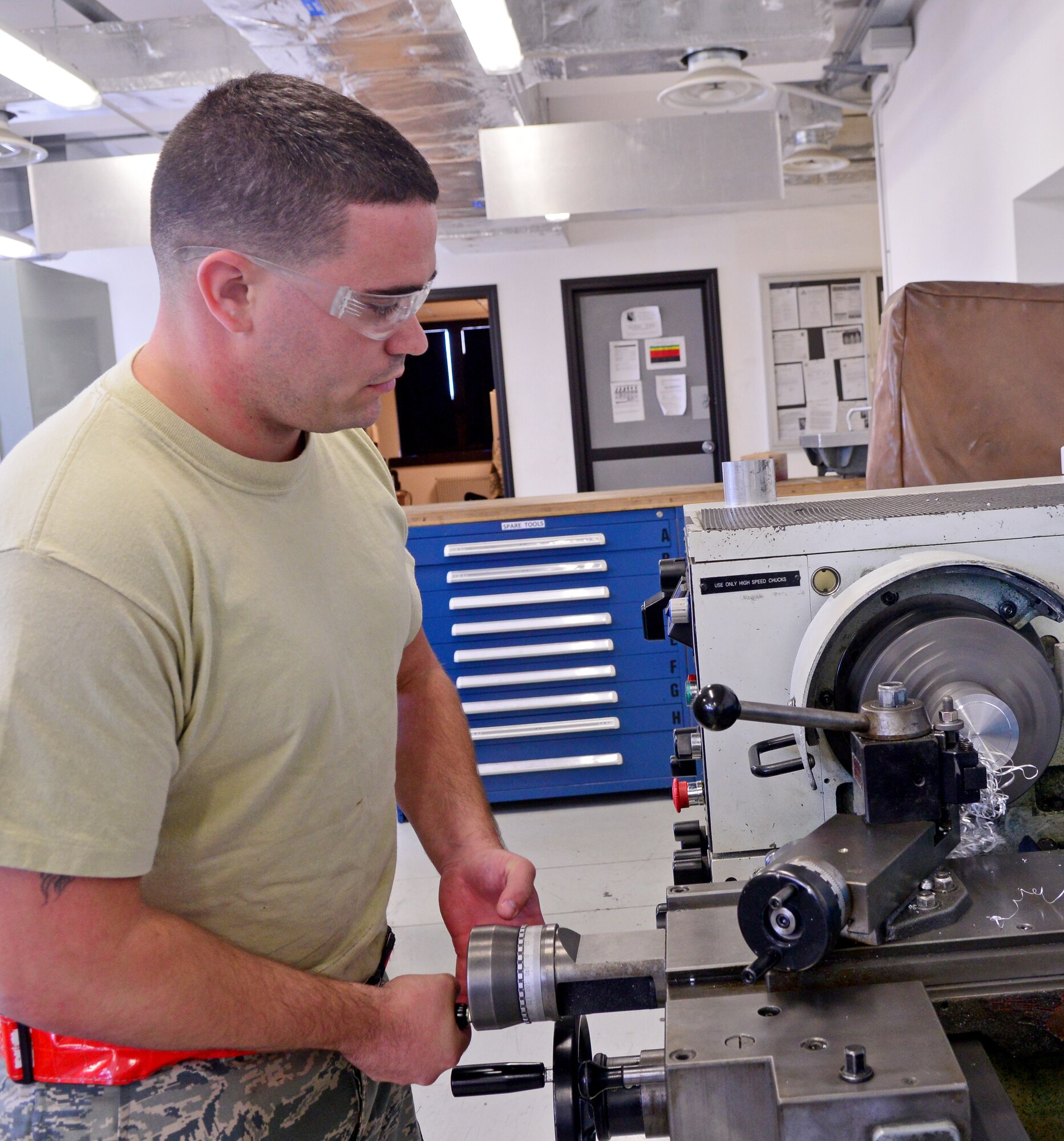 Senior Airman Troy Poe, 31st Maintenance Squadron aircraft metals technology journeyman, cuts down a stock of aluminum, Sept. 16, 2013, at Aviano Air Base, Italy. The primary mission of the metals technology shop is to support F-16 Fighting Falcons and transient aircraft that land here. (U.S. Air Force photo/Senior Airman Briana Jones)