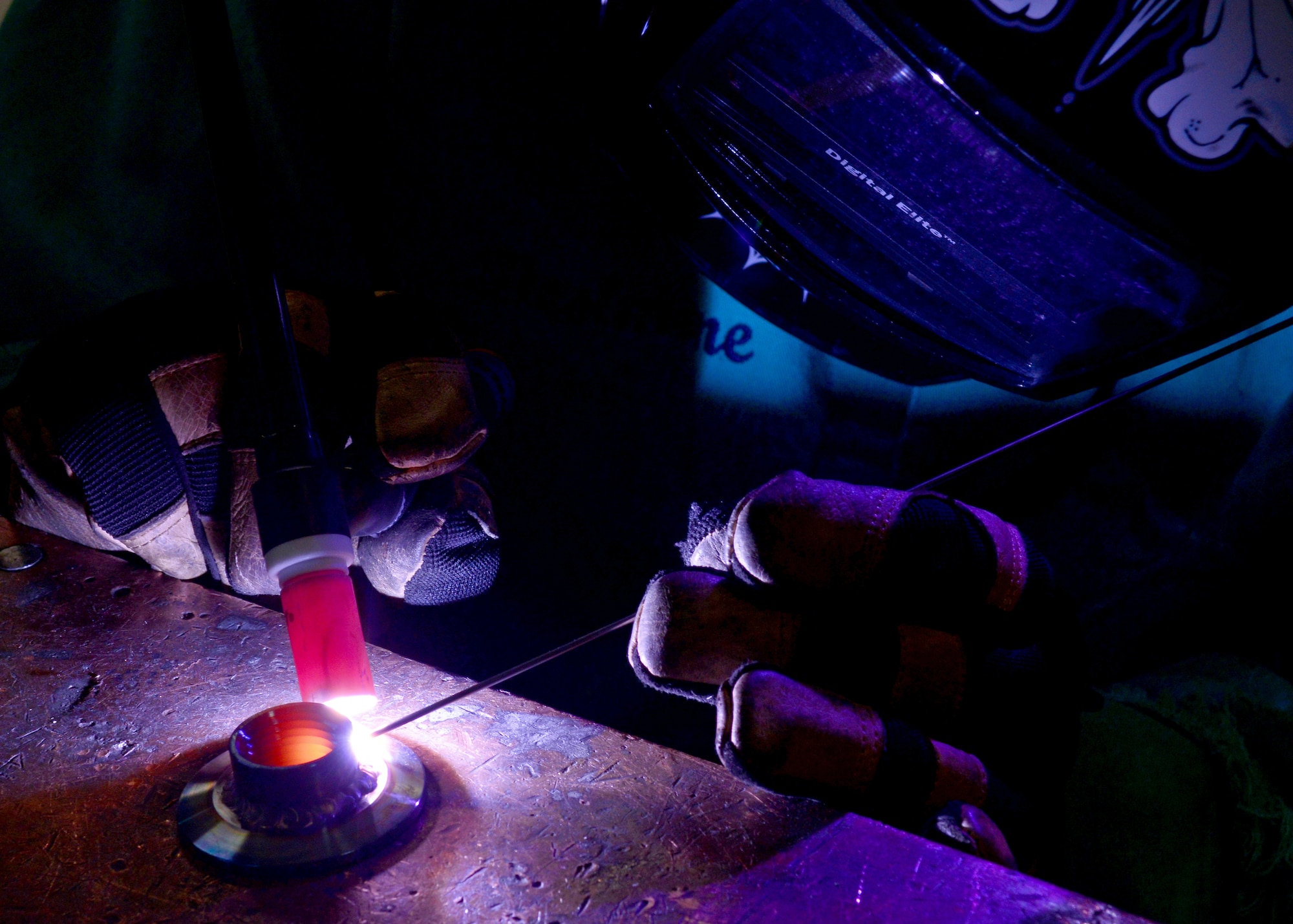A fitting for a coolant machine is welded, Sept. 16, 2013, at Aviano Air Base, Italy. Metals technology Airmen design, weld and fabricate machine precision tools, components and assemblies for aerospace weapon systems and support equipment. (U.S. Air Force photo/Senior Airman Briana Jones)