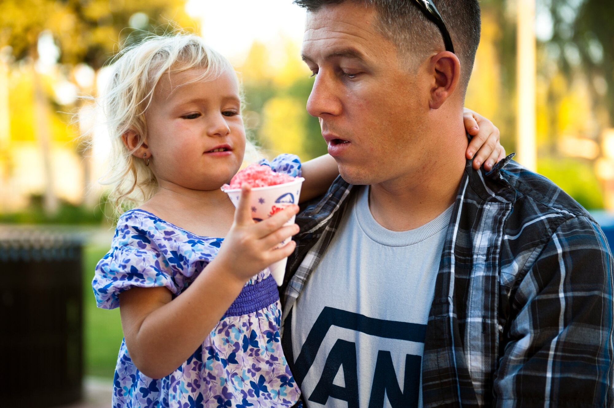 Tech. Sgt. Christopher Rekrut, 728th Air Mobility Squadron, and his daughter enjoy a snow cone during the Air Force Birthday Party Bash at Arkadas Park Sept. 20, 2013, at Incirlik Air Base, Turkey.  The Air Force was officially founded as a separate service Sept. 18, 1947. (U.S. Air Force photo by Senior Airman Daniel Phelps/Released)