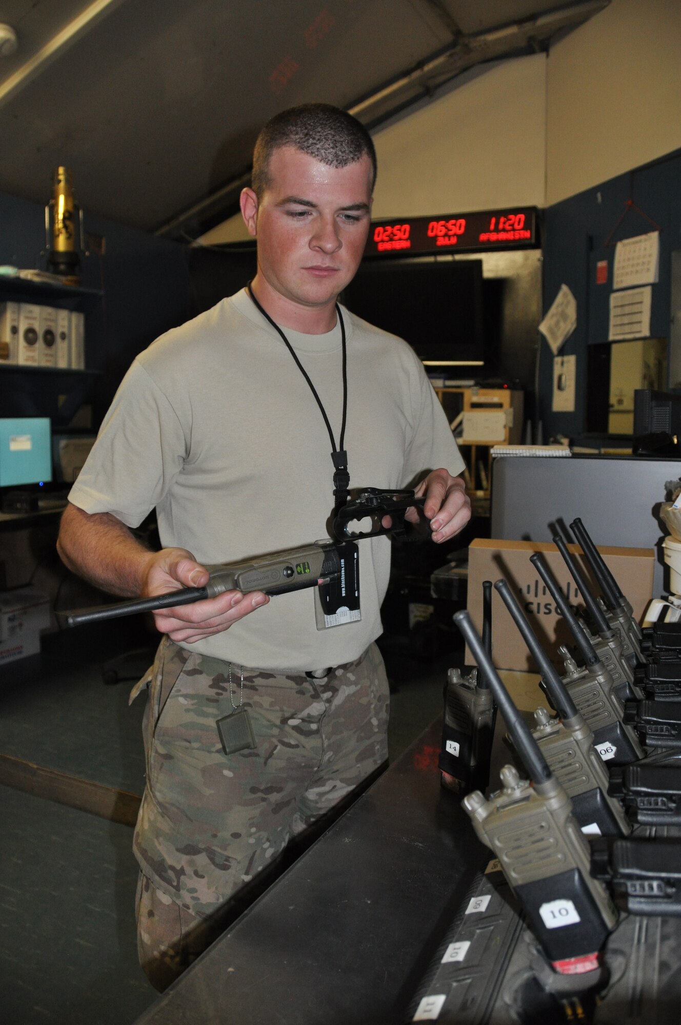 Staff Sgt. Jeffery Quinhoes, 455th Expeditionary Logistics Readiness Squadron fuels service center supervisor, deployed from Ellsworth AFB, S.D., and a native of Bernice, Okla., places a radio in a recharging station in the FSC at Bagram Airfield, Afghanistan, Sept. 18, 2013. The FSC tracks inventories to ensure fuel is available to meet air tasking order requirements and maintains accountability of its personnel, which are vital to sustaining operations with the periodic rocket here. (U.S. Air Force photo/Tech. Sgt. Rob Hazelett)