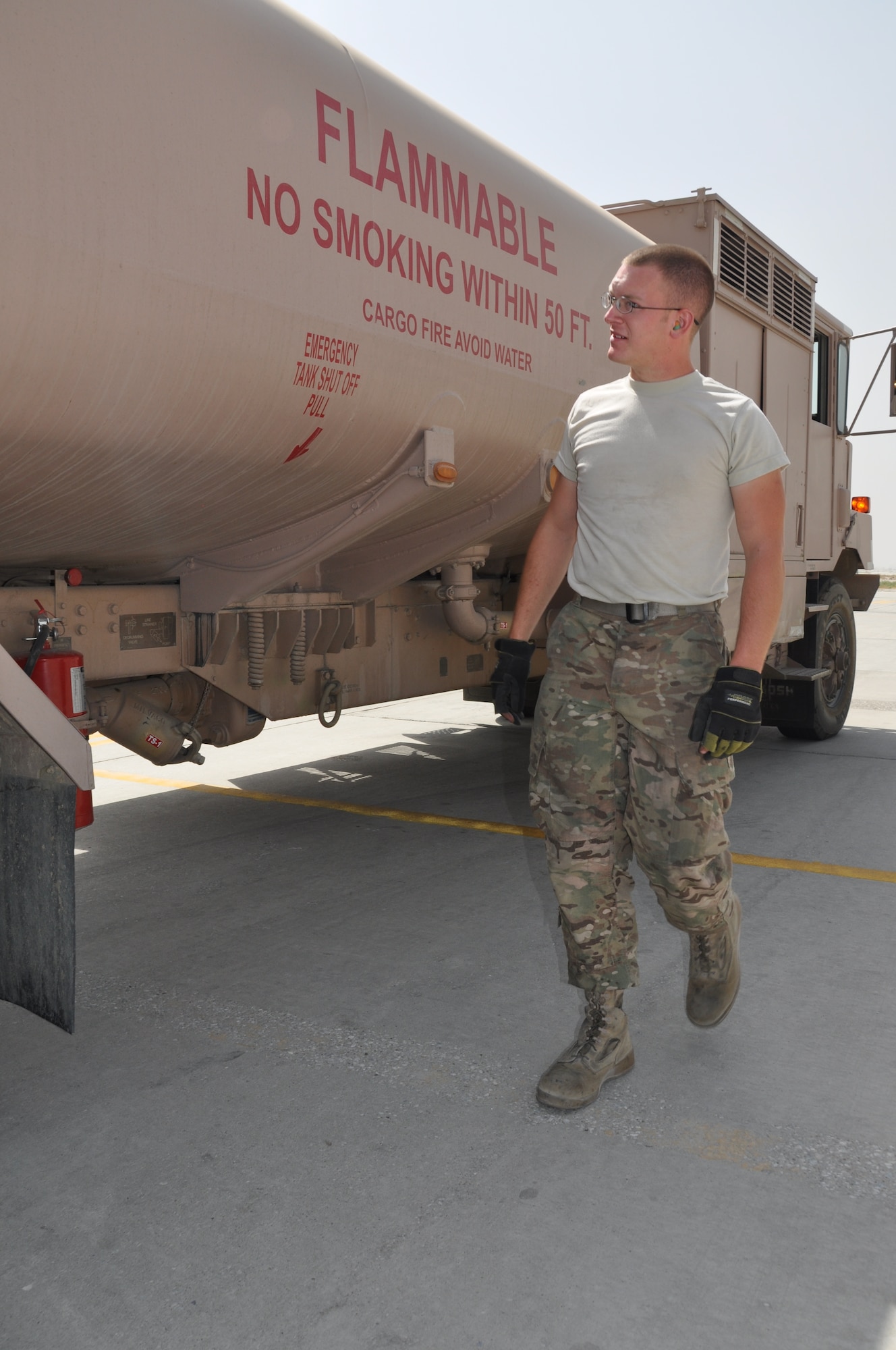 Senior Airman Robert Ellis, 455th Expeditionary Logistics Readiness Squadron refueling unit operator, deployed from Holloman Air Force Base, N.M., and a native of Gladstone, Mo., conducts a walk around his R-11 fuels truck after refueling an aircraft at Bagram Airfield, Afghanistan, Sept. 18, 2013. (U.S. Air Force photo/Tech. Sgt. Rob Hazelett)