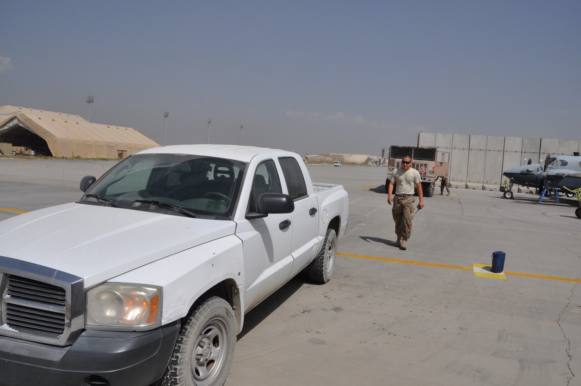 Staff Sgt. Andrew Mitalski, 455th Expeditionary Logistics Readiness Squadron distribution supervisor, deployed from Shaw Air Force Base, S.C., and a native of Hudson, Ohio, works as expeditor to assist a mobile refueling operator during a fuels run at Bagram Airfield, Afghanistan, Sept. 18, 2013. (U.S. Air Force photo/Tech. Sgt. Rob Hazelett)