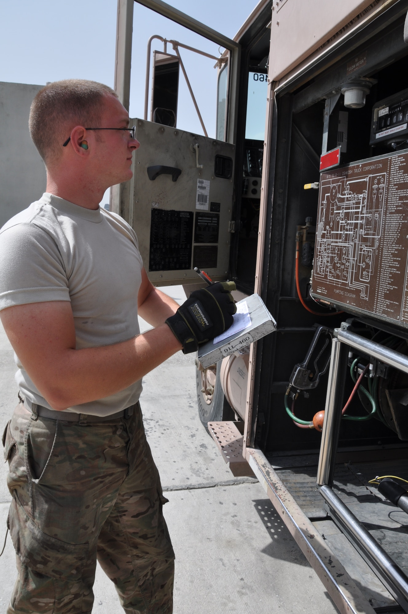 Senior Airman Robert Ellis, 455th Expeditionary Logistics Readiness Squadron refueling unit operator, deployed from Holloman Air Force Base, N.M., and a native of Gladstone, Mo., writes down the amount of gallons issued from the meter following after fueling an aircraft at Bagram Airfield, Afghanistan, Sept. 18, 2013. (U.S. Air Force photo/Tech. Sgt. Rob Hazelett)