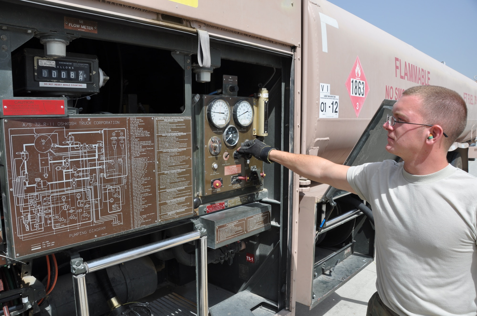 Senior Airman Robert Ellis, 455th Expeditionary Logistics Readiness Squadron refueling unit operator, deployed from Holloman Air Force Base, N.M., and a native of Gladstone, Mo., operates the engine throttle and monitors nozzle pressure while refueling an aircraft at Bagram Airfield, Afghanistan, Sept. 18, 2013. (U.S. Air Force photo/Tech. Sgt. Rob Hazelett)