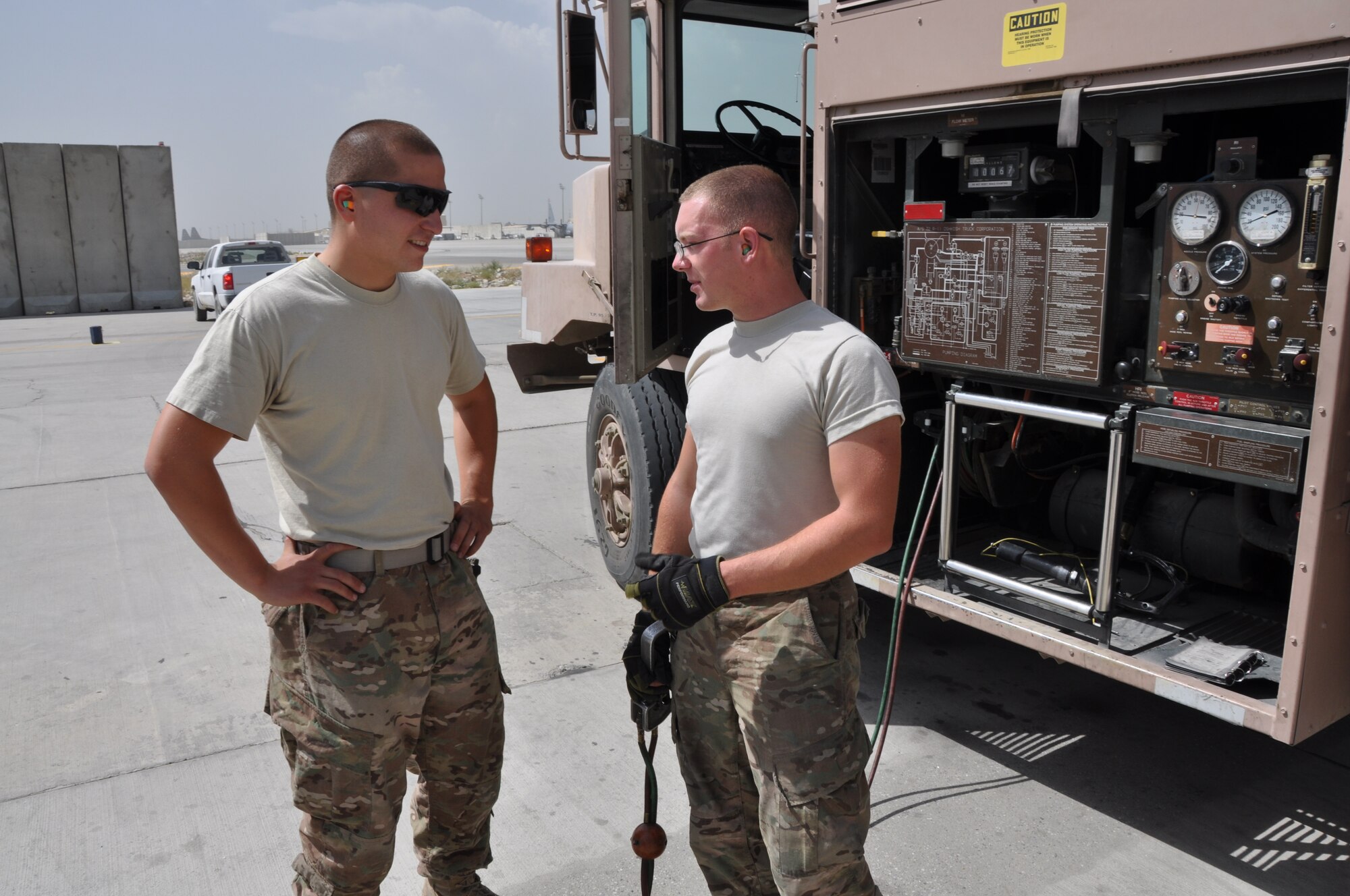 Staff Sgt. Andrew Mitalski, 455th Expeditionary Logistics Readiness Squadron distribution supervisor, deployed from Shaw Air Force Base, S.C., and a native of Hudson, Ohio, works as expeditor to assist Senior Airman Robert Ellis, 455th ELRS refueling unit operator, deployed from Holloman Air Force Base, N.M., and native of Gladstone, Mo., during a fuels run at Bagram Airfield, Afghanistan, Sept. 18, 2013. (U.S. Air Force photo/Tech. Sgt. Rob Hazelett)