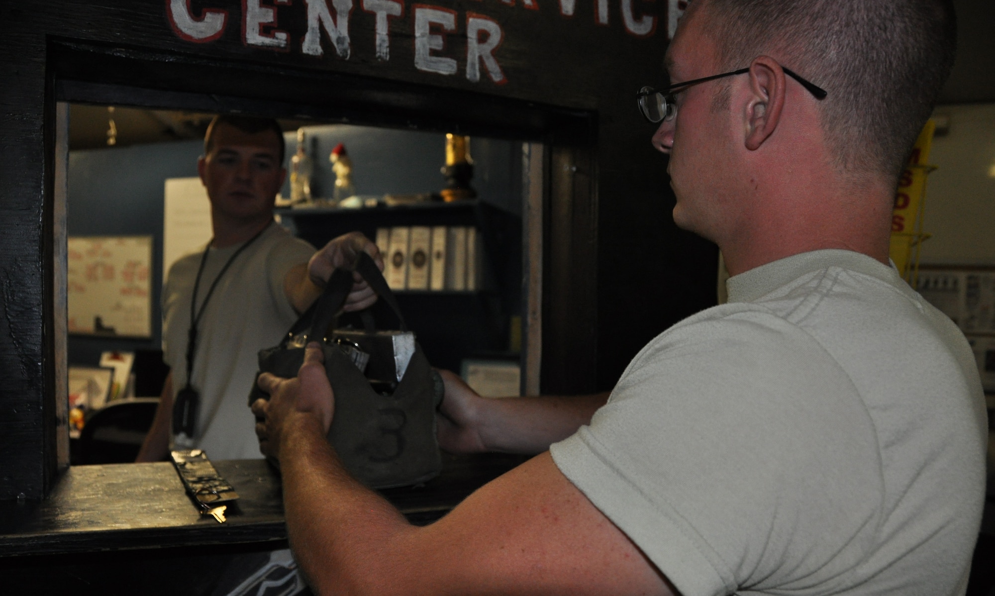 Senior Airman Robert Ellis, 455th Expeditionary Logistics Readiness Squadron refueling unit operator, deployed from Holloman Air Force Base, N.M., and a native of Gladstone, Mo., is issued a clipboard and checklist to take on a fuels run to refuel an aircraft from Staff Sgt. Jeffery Quinhoes, 455th ELRS fuels service center supervisor, deployed from Ellsworth AFB, S.D., and a native of Bernice, Okla., at Bagram Airfield, Afghanistan, Sept. 18, 2013. (U.S. Air Force photo/Tech. Sgt. Rob Hazelett)