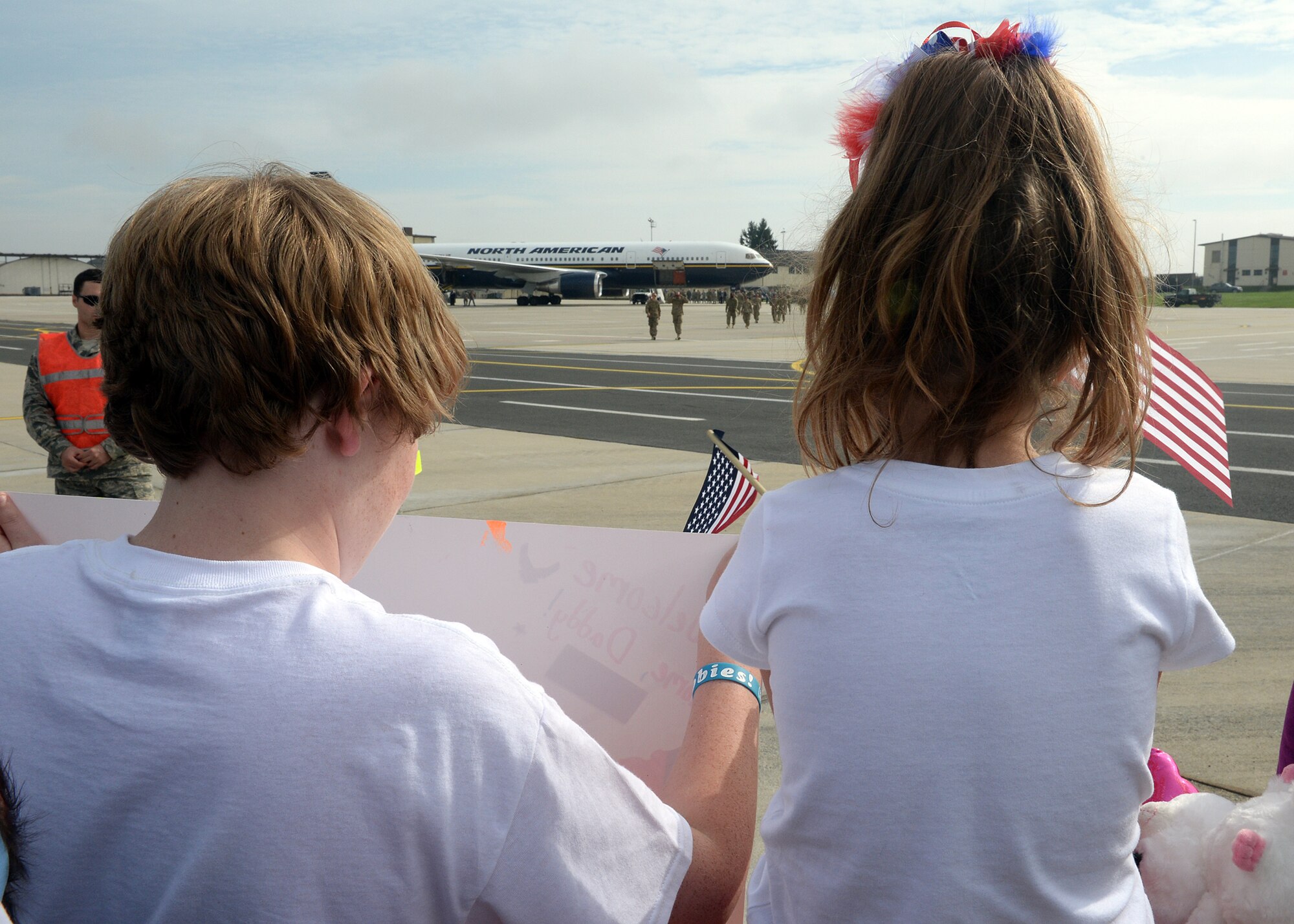 SPANGDAHLEM AIR BASE, Germany -- Conner Green and Brooklyn Scholl, children of Christy Scholl and U.S. Air Force Senior Master Sgt. Todd Scholl, watch as members of the 480th Fighter Squadron support community offload an aircraft here Sept. 21, 2013. The fighter squadron's support community comprises Airmen from many sections throughout the base: 480th Aircraft Maintenance Unit, 52nd Component Maintenance Squadron, 52nd Equipment Maintenance Squadron, 52nd Logistics Readiness Squadron. (U.S. Air Force photo by Staff Sgt. Daryl Knee/Released)