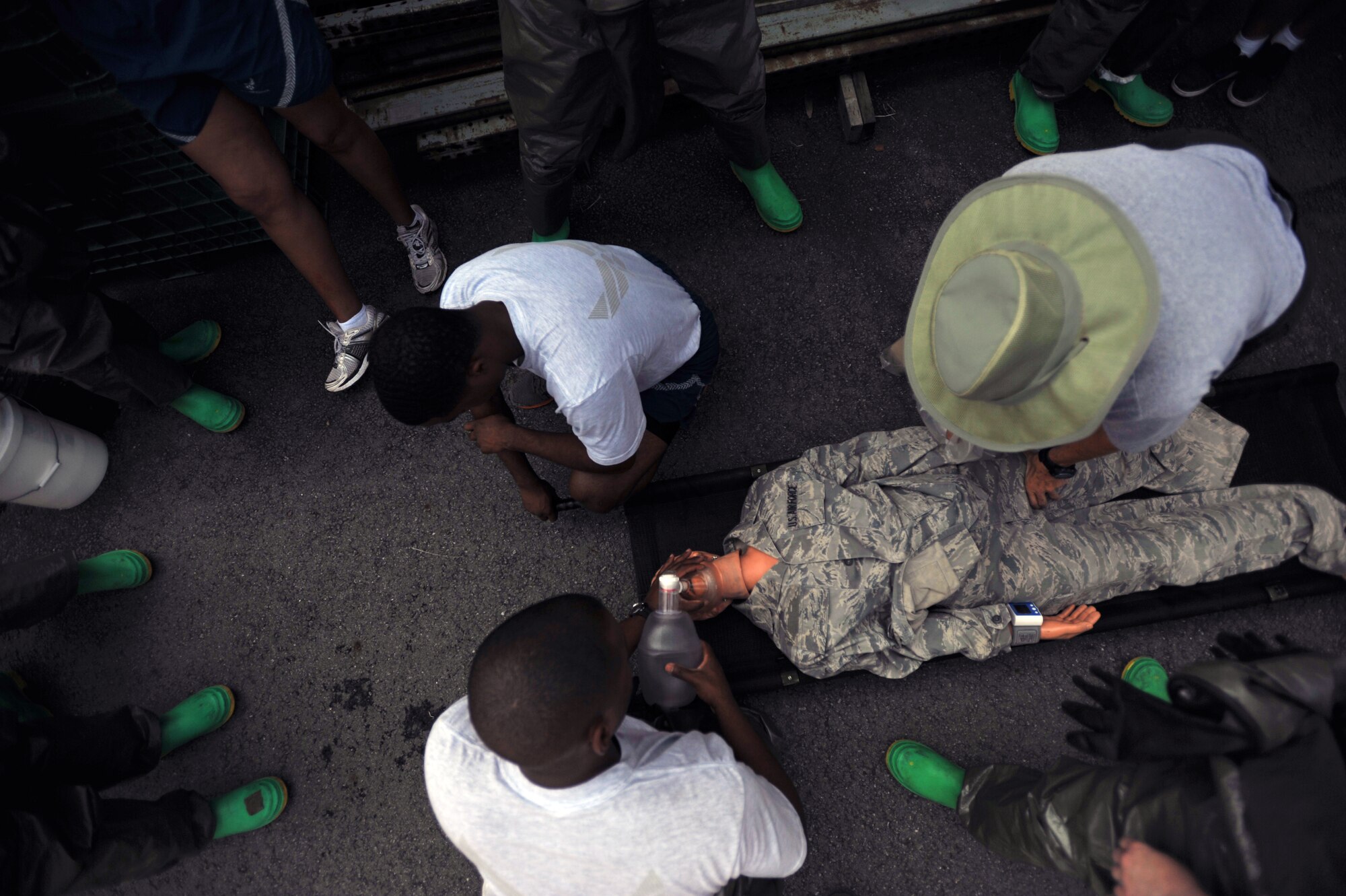 Members of the 51st Medical Group begin to process a training dummy through a decontamination area during an in-place patient decontamination training course at Osan Air Base, Republic of Korea, Sept. 19, 2013. The training course provided the participants with the skill set needed to respond and process patients through decontamination areas in cases of hazardous material exposure. (U.S. Air Force photo/Senior Airman Siuta B. Ika)