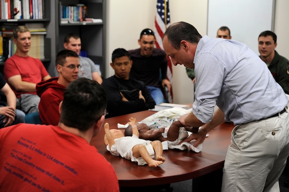 David Powell, 35th Medical Operations Squadron Family Advocacy program outreach manager, shows the proper way to change a diaper during a Dads 101 class at Misawa Air Base, Japan, Sept. 19, 2013. The purpose of Dads 101 is to help fathers learn about pregnancy, arrival prep, infant care and to raise awareness of Shaken Baby Syndrome. The Dads 101 class has become mandatory for any male wanting to take paternity leave. For more information, contact your first sgt. or commander about the WEASEL NOTAM – 35FW-13-15 Paternity Leave and Family Enhancement. (U.S. Air Force photo by Airman 1st Class Kaleb Snay)