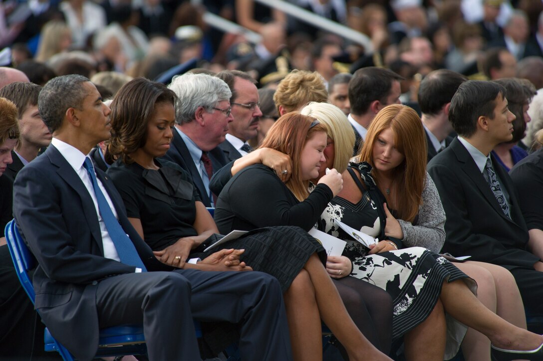 President Barack Obama, left, First Lady Michelle Obama, second from left, and friends and family members of those killed during the Washington Navy Yard shooting rampage attend a memorial service at the Marine Barracks in Washington D.C., Sept. 22, 2013. 