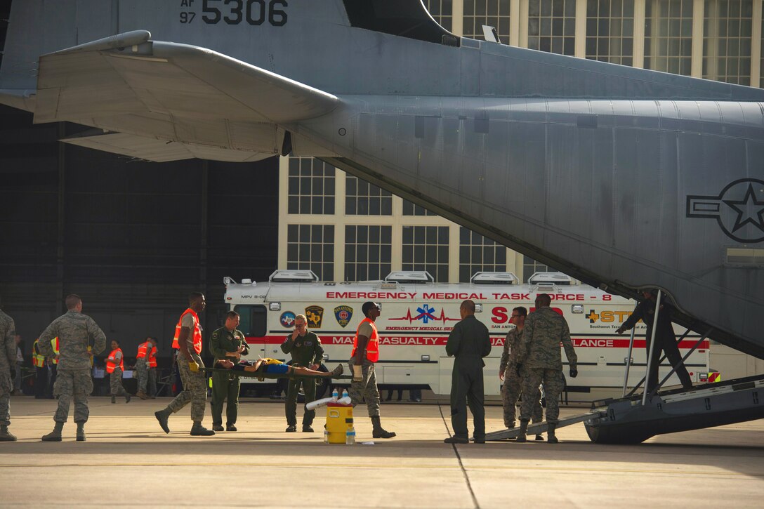 Air Force Reserve airmen load a patient onto a WC-130J Hurricane Hunter aircraft during an aeromedical evacuation training mission on Joint Base San Antonio-Lackland, Texas, Sept. 19, 2013. The airmen are assigned to the 433rd Training Wing. 