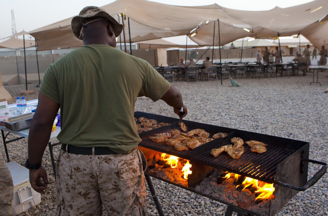 A food service specialist with Combat Logistics Regiment 2, Regional Command (Southwest), grills hamburger patties at Camp Leatherneck, Helmand province, Afghanistan, Sept. 12, 2013. The unit hosted numerous senior commanders and provided on-site food service while the leaders discussed future operations.