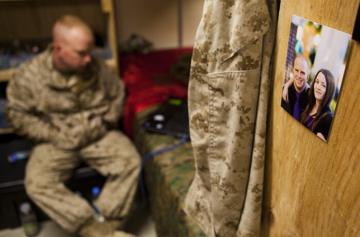 Cpl. James Register, a Marine with Combat Logistics Regiment 2, Regional Command (Southwest), waits by his computer during a video-chat session with his wife at Camp Leatherneck, Helmand province, Afghanistan, Sept. 17, 2013. Register watched the birth of his baby girl on a computer more than 7,000 miles away from home.
