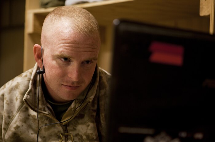 Cpl. James Register, a Marine with Combat Logistics Regiment 2, Regional Command (Southwest), watches the delivery of his first child on his computer screen at Camp Leatherneck, Helmand province, Afghanistan, Sept. 18, 2013. Register watched the birth of his baby girl on a computer more than 7,000 miles away from home.