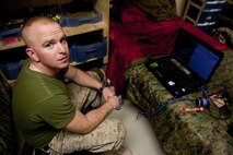 Cpl. James Register, a Marine with Combat Logistics Regiment 2, Regional Command (Southwest), waits by his computer for a video-chat session with his wife at Camp Leatherneck, Helmand province, Afghanistan, Sept. 17, 2013. Register watched the birth of his baby girl on a computer more than 7,000 miles away from home.