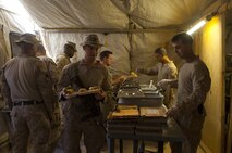 Marines pass through a mess hall run by food service specialists with Combat Logistics Regiment 2, Regional Command (Southwest), at Forward Operating Base Shir Ghazi, Helmand province, Afghanistan, Sept. 16, 2013. The Marines provide daily food service in austere environments for servicemembers operating throughout the province.