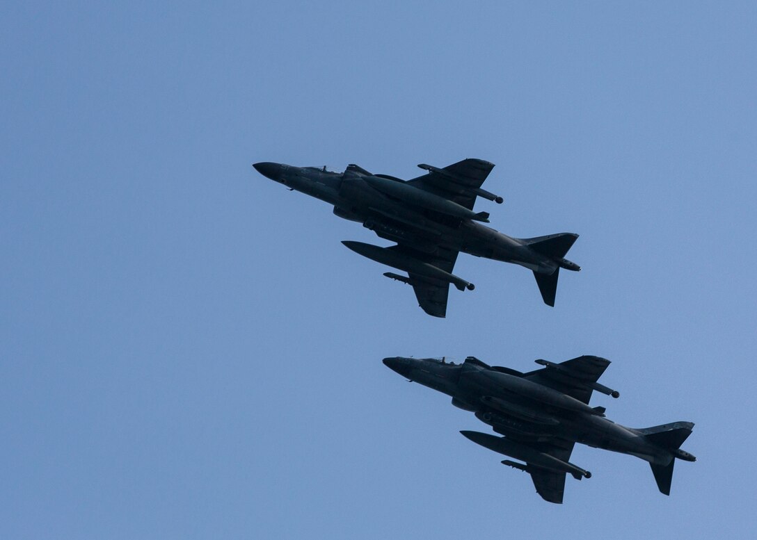 Two AV-8B Harriers assigned to Marine Medium Tiltrotor Squadron (VMM) 266 (Reinforced), 26th Marine Expeditionary Unit (MEU), fly past the USS Kearsarge (LHD 3), at sea, Sept. 24, 2013. The 26th MEU is a Marine Air-Ground Task Force forward-deployed to the U.S. 5th and 6th Fleet areas of responsibility aboard the Kearsarge Amphibious Ready Group serving as a sea-based, expeditionary crisis response force capable of conducting amphibious operations across the full range of military operations. (U.S. Marine Corps photo by Sgt. Christopher Q. Stone, 26th MEU Combat Camera/Released)