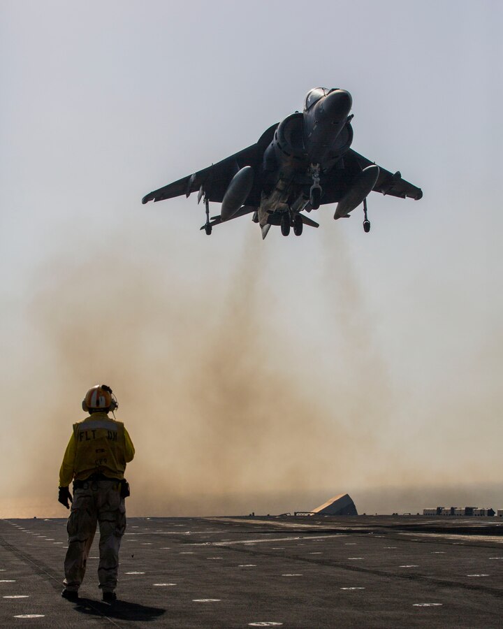 An AV-8B Harrier assigned to Marine Medium Tiltrotor Squadron (VMM) 266 (Reinforced), 26th Marine Expeditionary Unit (MEU), lands on the flight deck of the USS Kearsarge (LHD 3), at sea, Sept. 24, 2013. The 26th MEU is a Marine Air-Ground Task Force forward-deployed to the U.S. 5th and 6th Fleet areas of responsibility aboard the Kearsarge Amphibious Ready Group serving as a sea-based, expeditionary crisis response force capable of conducting amphibious operations across the full range of military operations.  (U.S. Marine Corps photo by Sgt. Christopher Q. Stone, 26th MEU Combat Camera/Released)