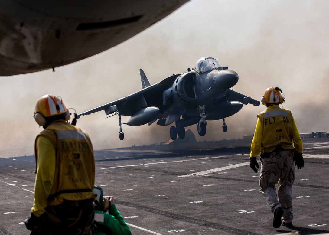 An AV-8B Harrier assigned to Marine Medium Tiltrotor Squadron (VMM) 266 (Reinforced), 26th Marine Expeditionary Unit (MEU), lands on the flight deck of the USS Kearsarge (LHD 3), at sea, Sept. 24, 2013. The 26th MEU is a Marine Air-Ground Task Force forward-deployed to the U.S. 5th and 6th Fleet areas of responsibility aboard the Kearsarge Amphibious Ready Group serving as a sea-based, expeditionary crisis response force capable of conducting amphibious operations across the full range of military operations.  (U.S. Marine Corps photo by Sgt. Christopher Q. Stone, 26th MEU Combat Camera/Released)