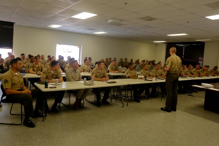 First Sgt. Jason Politte, Headquarters Company first sergeant, 5th Marine Regiment, talks to noncommissioned officers during a weekly professional military education session here, Sept. 20, 2013. Politte, a native of Papillion, Neb., said the regiment's focus on small-unit leaders benefits not only the Marine Corps but also society. His PME focused on the NCOs' roles as mentors and leaders with their junior Marines.