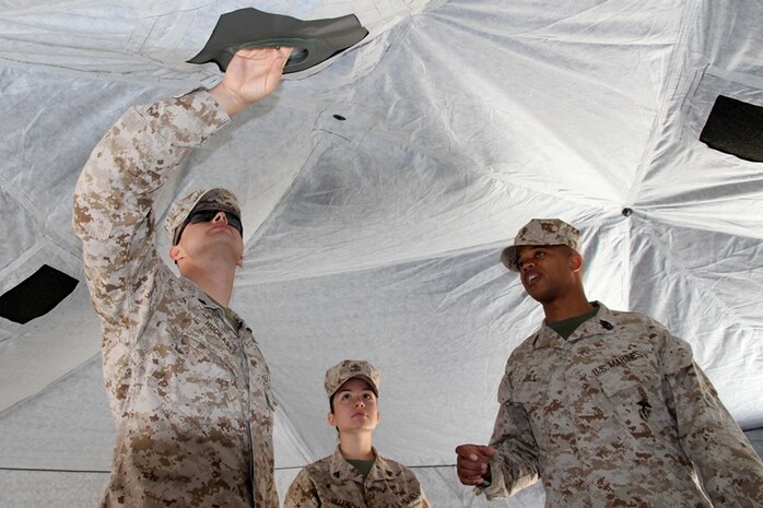 Marines from the Marine Corps Combat Development Command explore the inside of the Arctic Shelter System during the Modern Day Marine Expo Sept. 24 at Marine Corps Base Quantico, Va. At the expo, Marines can see the gear Marine Corps Systems Command program offices are fielding and will field in the future. 