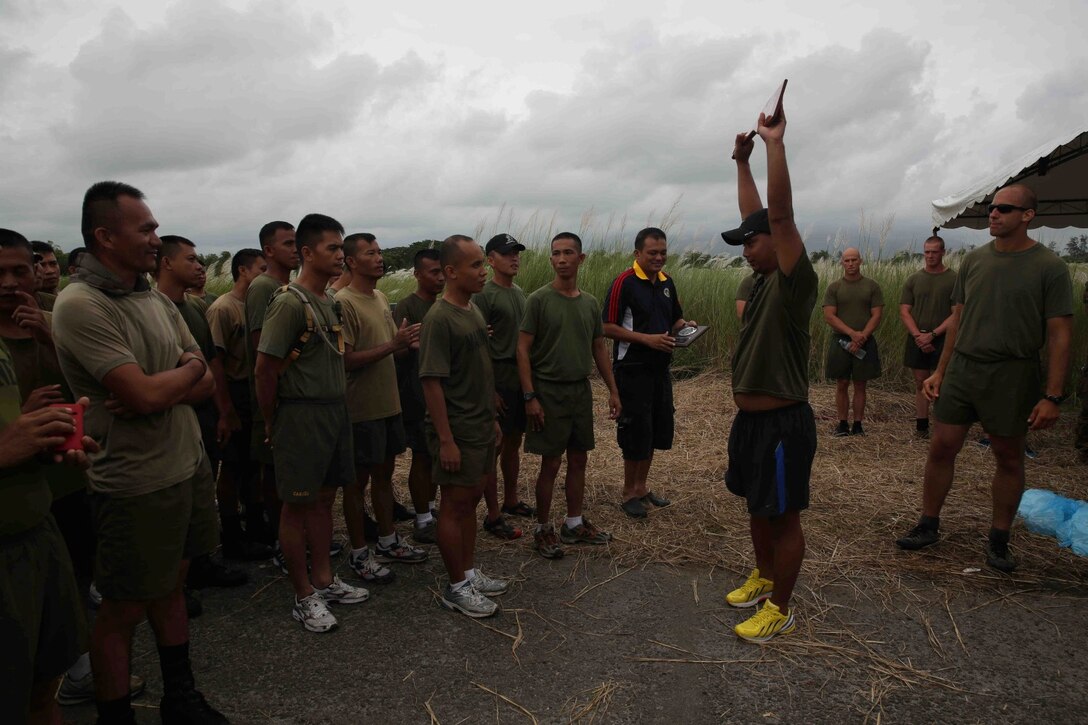 U.S. Marines with the 13th Marine Expeditionary Unit participate in a celebratory Warrior Night with Philippine Marines during Amphibious Landing Exercise 2014 (PHIBLEX 14) at Naval Station Leovigildo Gantioqui, San Antonio, Zambales, Republic of the Philippines, Sept. 21, 2013. PHIBLEX is a bilateral training exercise that demonstrates the commitment of the United States and Republic of the Philippines to mutual security and their long-term partnership. It also ensures the readiness of a bilateral force to rapidly respond to regional humanitarian crises. (U.S. Marine Corps photo by Cpl. David Gonzalez, 13th Marine Expeditionary Unit Combat Camera/Released)