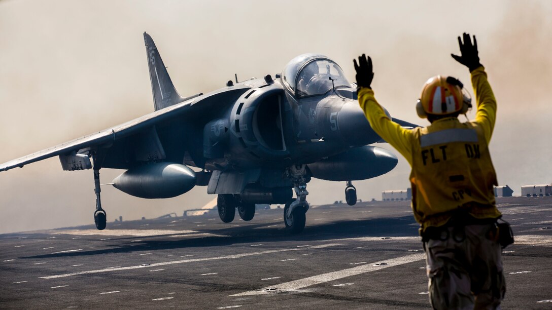 An AV-8B Harrier assigned to Marine Medium Tiltrotor Squadron (VMM) 266 (Reinforced), 26th Marine Expeditionary Unit (MEU), lands on the flight deck of the USS Kearsarge (LHD 3), at sea, Sept. 24, 2013. The 26th MEU is a Marine Air-Ground Task Force forward-deployed to the U.S. 5th and 6th Fleet areas of responsibility aboard the Kearsarge Amphibious Ready Group serving as a sea-based, expeditionary crisis response force capable of conducting amphibious operations across the full range of military operations.  (U.S. Marine Corps photo by Sgt. Christopher Q. Stone, 26th MEU Combat Camera/Released)