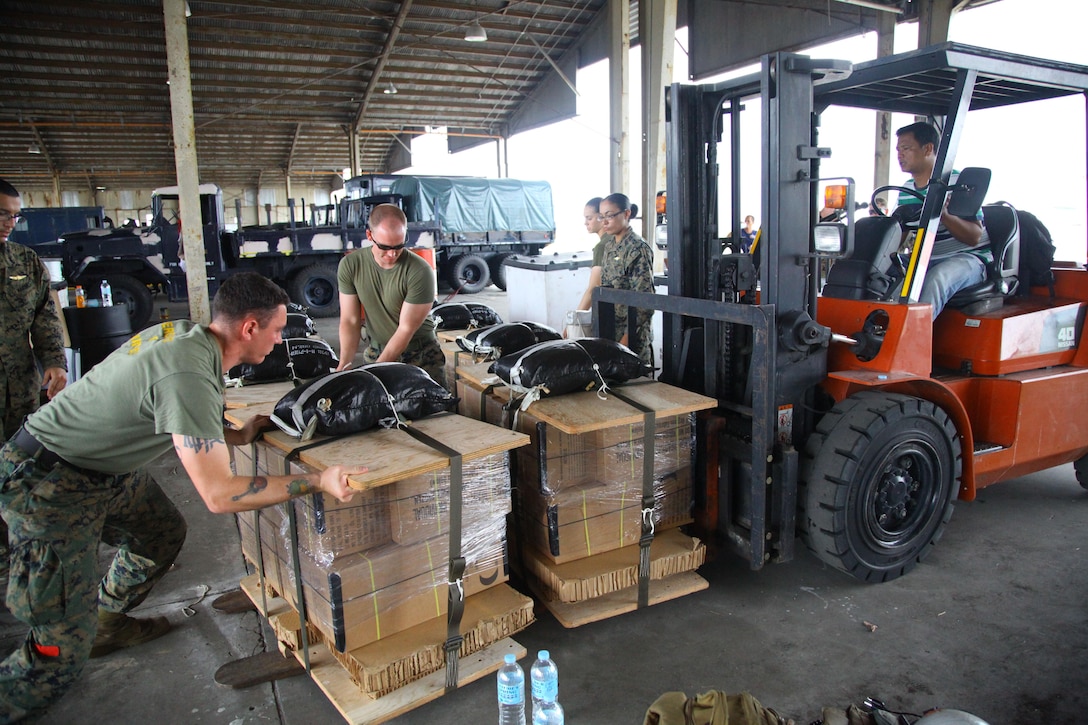 Marines prepare pallets of meals-ready-to-eat to be loaded into an MV-22B Osprey at Clark Air Field for a supply drop mission over Crow Valley Sept. 19 during Amphibious Landing Exercise 2014. Bilateral Philippine-U.S. Marine Corps training sustains and reinforces the foundation and framework for a bilateral force to respond rapidly and effectively to regional humanitarian crises. The Marines are with Combat Logistics Battalion 13, 13th Marine Expeditionary Unit's logistics combat element. Clark Air Field is located in Pampanga, Republic of the Philippines. Crow Valley is located in Capas, Tarlac, Philippines.