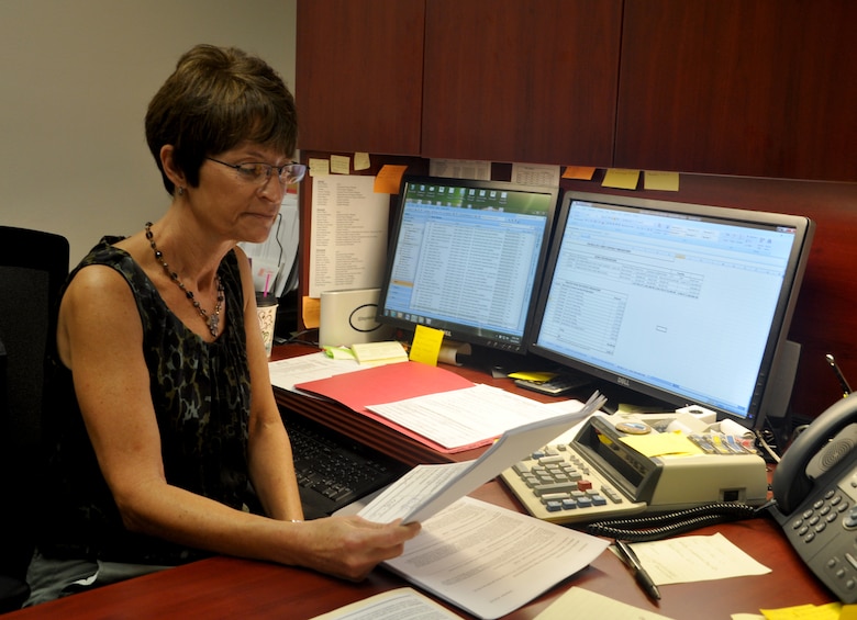 Virginia "Ginger" Auld, a supervisory accountant with the U.S. Army Corps of Engineers Savannah District, reviews financial documents in her office. Auld was named the USACE Resource Management Professional of the Year for her accomplishments in fiscal year 2012. USACE photo by Tracy Robillard.