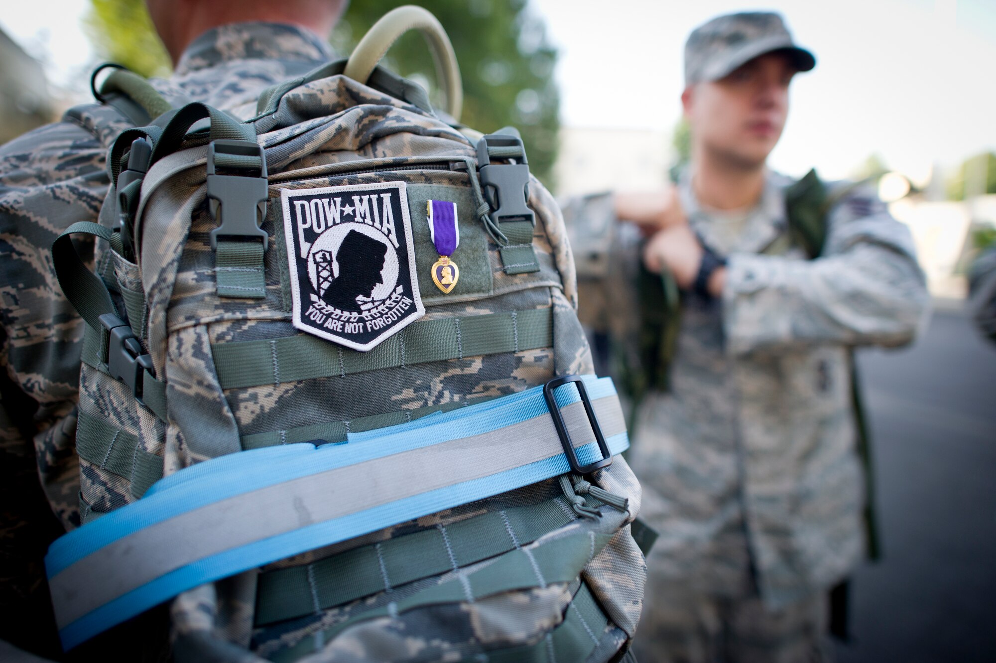 YOKOTA AIR BASE, Japan -- Master Sgt Theodore Fest, 374th Security Forces Squadron displays the Prisoner of War/Missing in Action patch and his Purple Heart decoration on his backpack during the POW/MIA ruck march Sept. 20, 2013 at Yokota Air Base, Japan. Members loaded their rucks and completed an almost 8 mile march around the perimeter of the base in honor of those who have been Prisoners of War or are still missing.  (U.S. Air Force photo by Staff Sgt. Stacy Moless/released)    