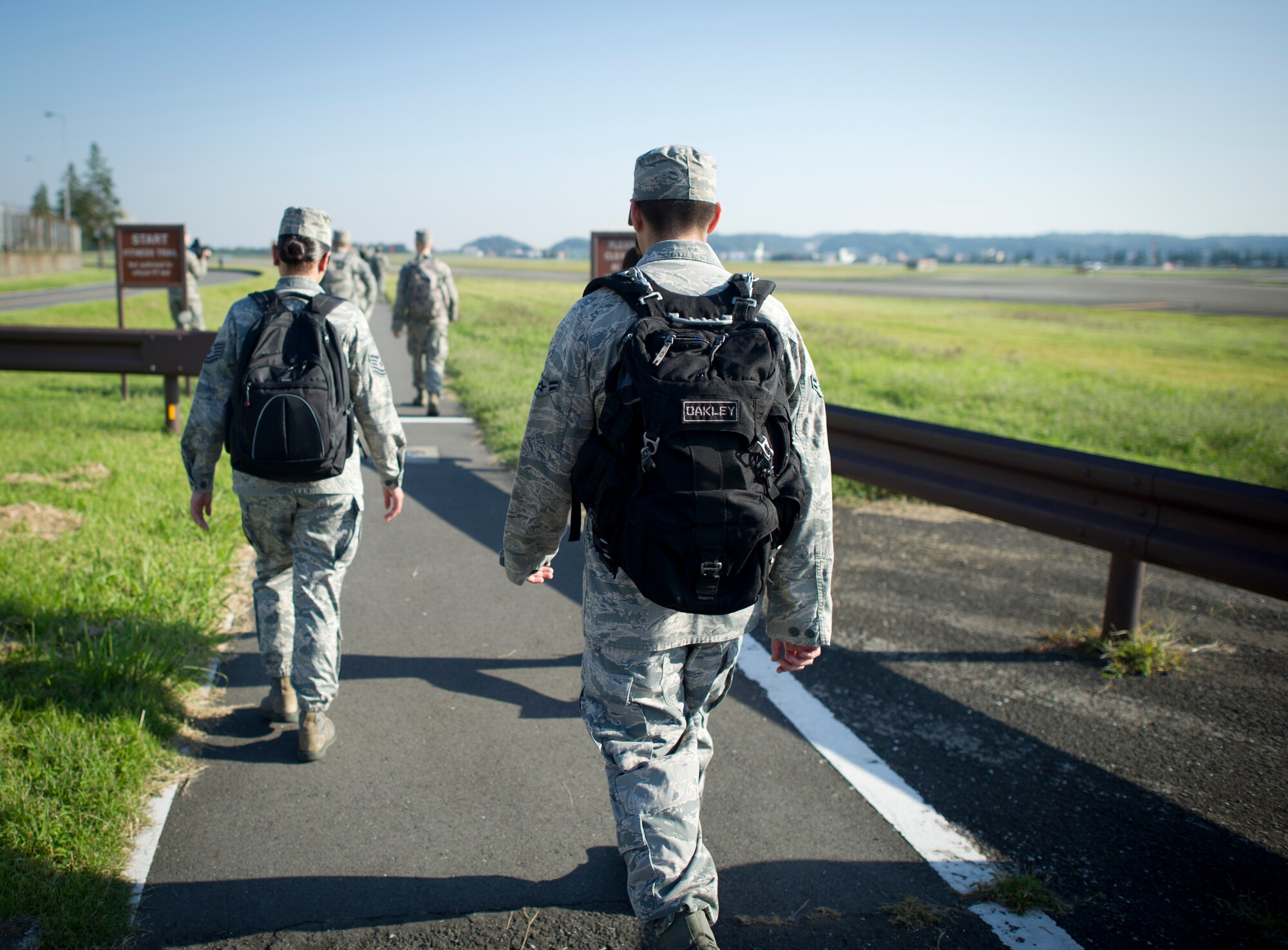 YOKOTA AIR BASE, Japan -- Airmen participate in a ruck march during the Prisoner of War/Missing in Action day march Sept. 20, 2013 at Yokota Air Base, Japan. Members loaded their rucks and completed an almost 8 mile march around the perimeter of the base in honor of those who have been Prisoners of War or are still missing (U.S. Air Force photo by Staff Sgt. Stacy Moless/released)   