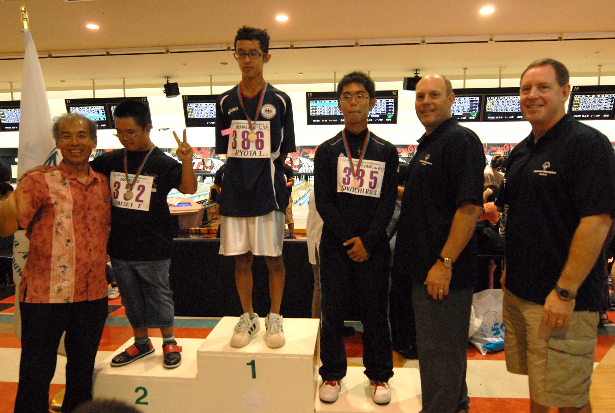 U.S. Air Force Brig. Gen. James Hecker (right), 18th Wing commander, along with Kyoji Shimabukuro (left), Okinawa City Board of Education chairman, and Col.  Jeffery Ullmann, 18th Mission Support Group commander, pose with participants after awarding the medals at the Kadena Special Olympics bowling event in Mihama, Okinawa, Japan, Sept. 21, 2013. This is the 14th year that Okinawan and military communities will participate in or support KSO through events such as this bowling event, one of several to precede the KSO game day which is scheduled for Nov. 2. (U.S. Air Force photo by Staff Sgt. Lauren Snyder)