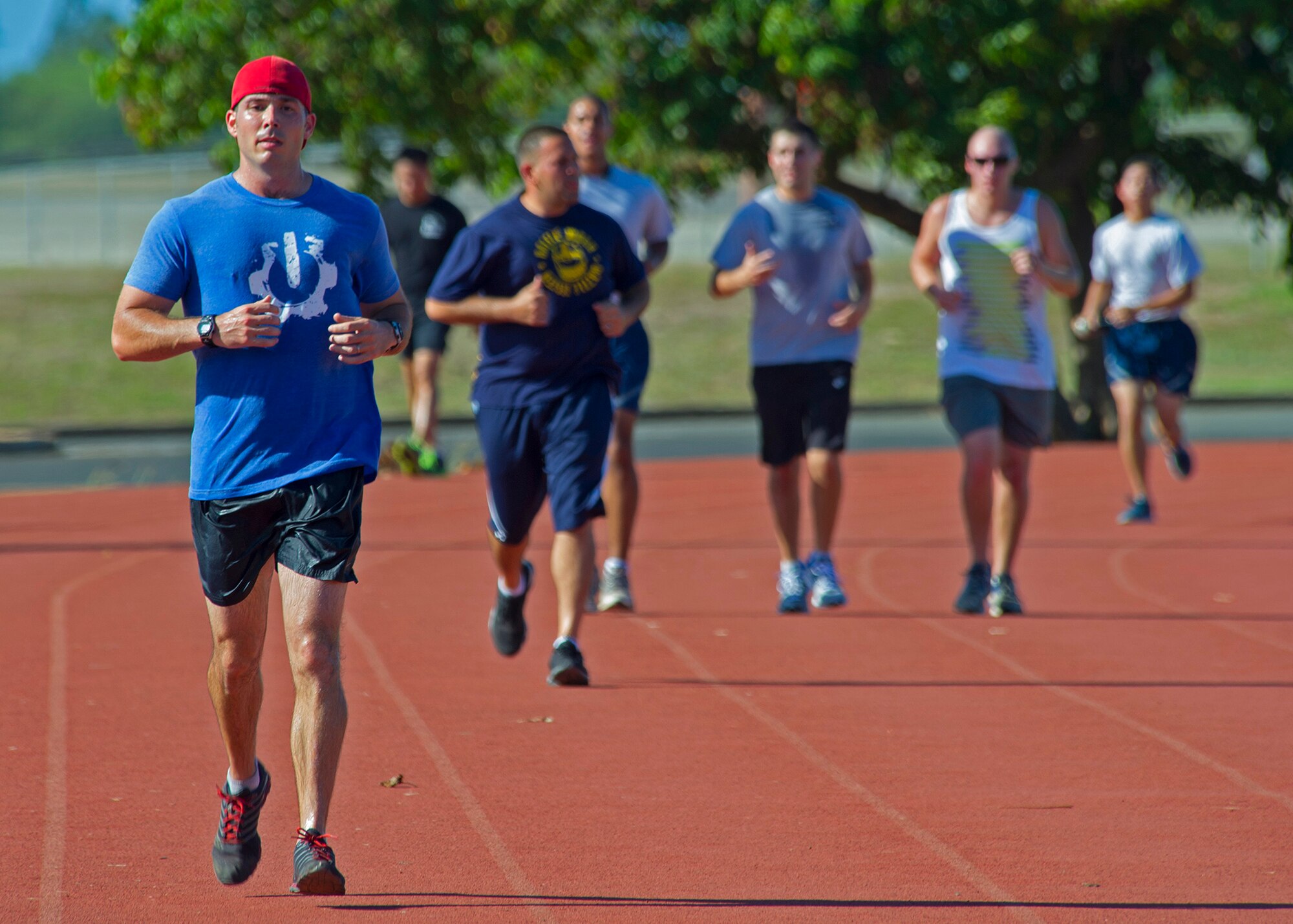 Capt. Michael Kerschbaum 96th Airlift Refueling Squadron KC-135 pilot, left, leads the pack during a 24-hour prisoners of war/missing in action run at Earhart Field, Joint Base Pearl Harbor-Hickam, Hawaii, Sept. 19, 2013. Kerschbaum vowed to run 100 miles or for 24 hours whichever came first, in honor and memoriam of all the POW/MIAs. (U.S. Air Force photo/Tech. Sgt. Jerome S. Tayborn)