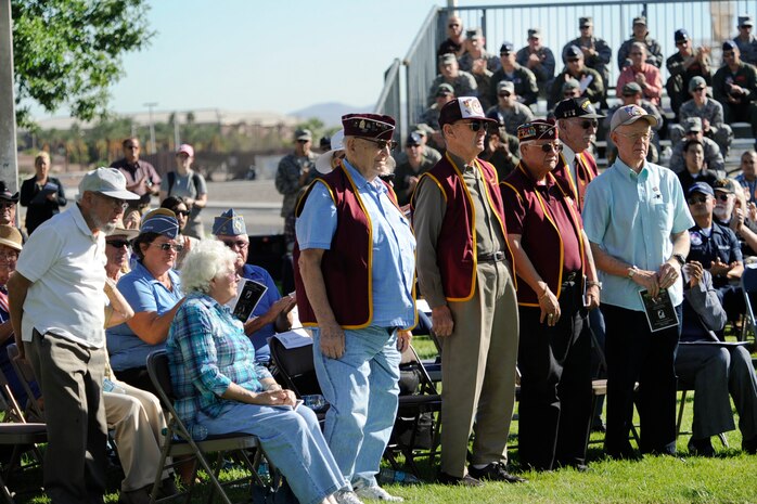 Members from the Las Vegas 7-11 Chapter of American Ex-Prisoners of War stand for recognition during the National Prisoner of War/Missing in Action Remembrance ceremony Sept. 20, 2013, at Nellis Air Force Base, Nev. The National POW/MIA Recognition Day is observed across the nation on the third Friday of September each year. On this day, many Americans take time to remember those who were prisoners of war and those who are missing in action. (U.S. Air Force photo by Lorenz Crespo)