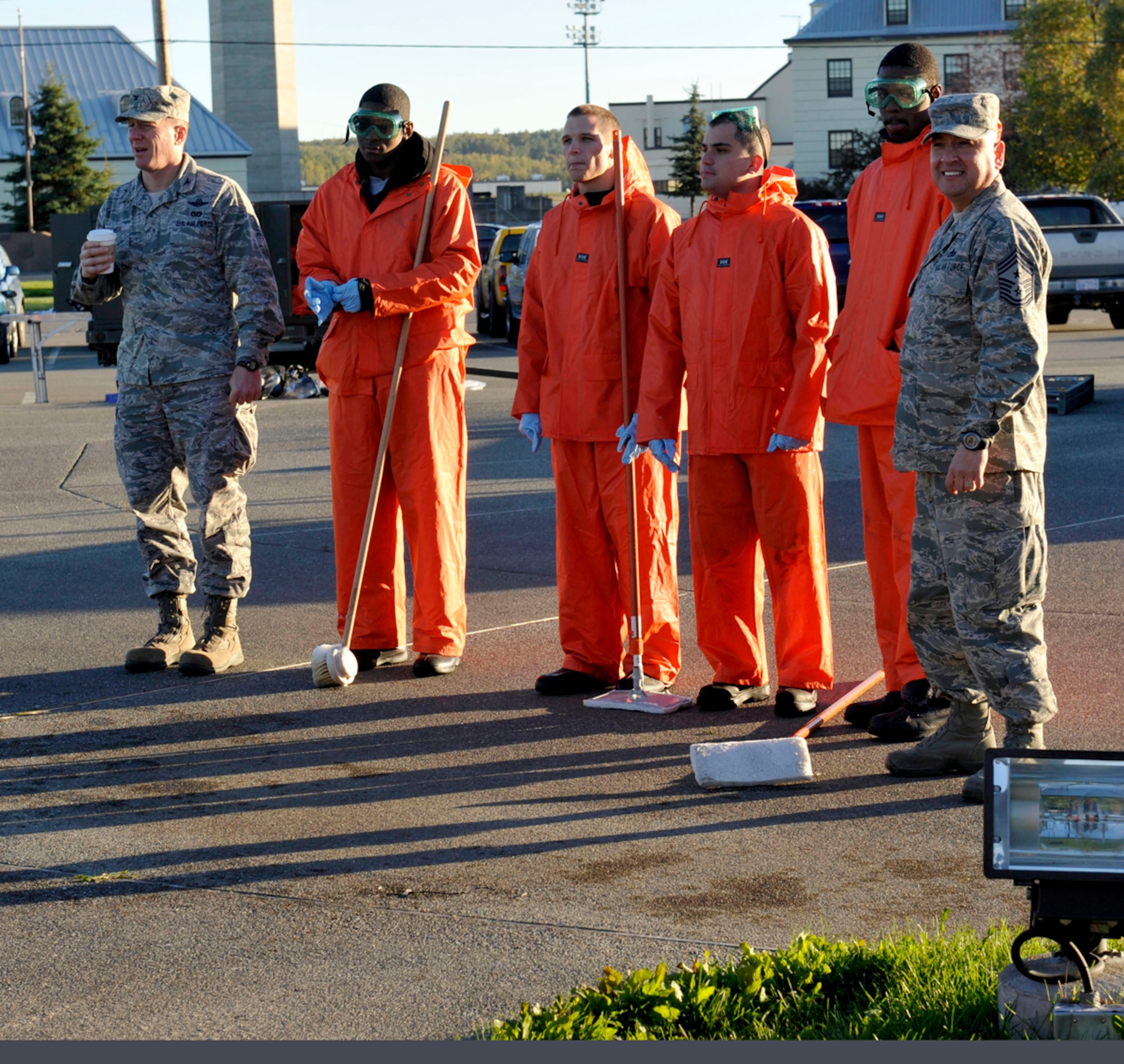 Airmen wait to clean an aircraft with Air Force Col. Michael Grismer, 3rd Wing vice commander, and Air Force Chief Master Sgt. Jose Barraza, 3rd Wing command chief, at Heritage Park on Joint Base Elmendorf-Richardson, Sept. 20. The 3rd Wing Aircraft Structural Maintenance Shop, Fabrication Flight, washes the static aircraft twice a year for inspections to determine if repairs or paint jobs are necessary. (U.S. Air Force photo/Airman 1st Class Tammie Ramsouer)