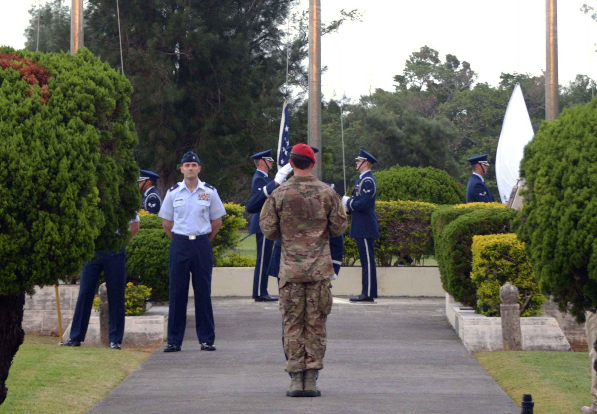 Staff Sgt. Aaron Davis, 320th Special Tactics Squadron combat controller, presents the POW/MIA flag to a member of the 18th Wing honor guard during the National POW/MIA flag ceremony Sept. 20, 2013 on Kadena Air Base, Japan.  National POW/MIA Recognition Day is one of six days throughout the year that Congress mandates the flying of POW/MIA flag.  (Air Force photo by Tech. Sgt. Kristine Dreyer)