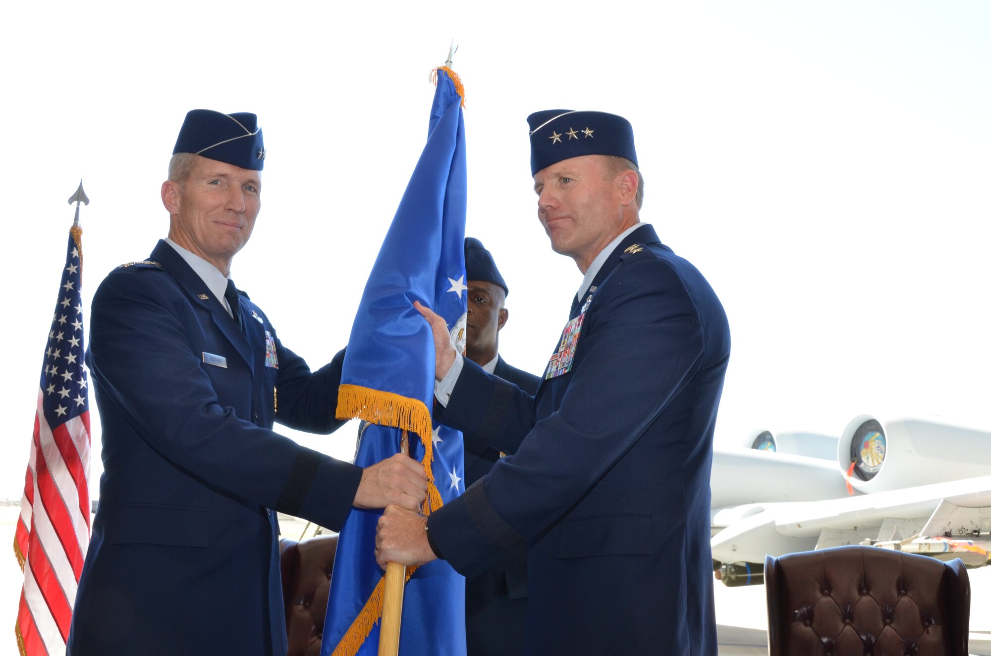 Gen. Mike Hostage, Commander, Air Combat Command, passes the guidon to Lt. Gen. Tod Wolters, 12th Air Force (Air Forces Southern) commander, during a change of command ceremony at Davis-Monthan Air Force Base, Ariz., Sept. 24, 2013. The passing of the guidon marks the beginning of Wolters tour as commander of 12th Air Force (Air Forces Southern). (U.S. Air Force photo by Staff Sgt. Adam Grant/Released)