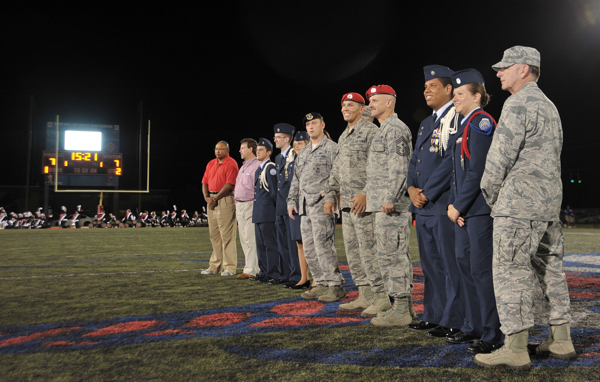 Airmen, Wounded Warriors and Junior ROTC cadets line up during a high school football game half time show in Fort Walton Beach, Fla., Sept. 20, 2013. Fort Walton Beach High School honored two wounded warriors during the football game. (U.S. Air Force photo /Airman 1st Class Andrea Posey)