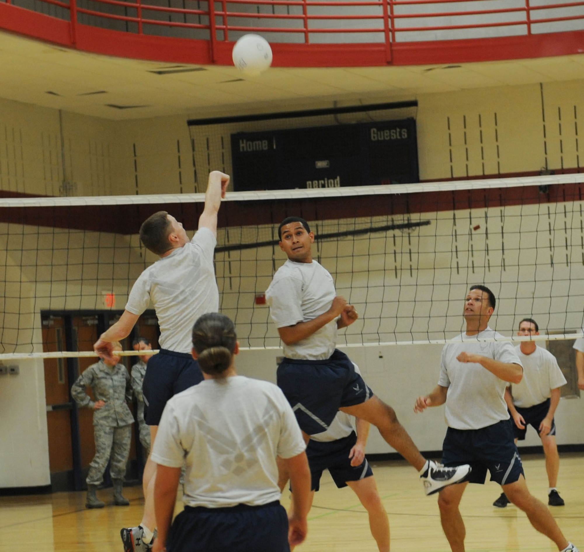 Airman Leadership School students square off against base leaders during a volleyball game in the Bellamy Fitness Center at Ellsworth Air Force Base, S.D., Sept. 17, 2013. ALS Airmen utilized their newly acquired leadership and teamwork skills to compete against base leaders.. (U.S. Air Force photo by Airman 1st Class Rebecca Imwalle / Released)