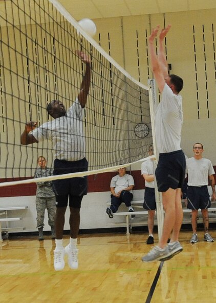 Senior Airman Andrew Menegahini, 28th Security Forces Squadron response force leader, defends a shot by Col. Anthony Mims, 28th Logistics Readiness Squadron commander, during a volleyball game in the Bellamy Fitness Center at Ellsworth Air Force Base, S.D., Sept. 17, 2013. In an effort to keep the competition friendly, three sets were played to determine which team would emerge victorious. (U.S. Air Force photo by Airman 1st Class Rebecca Imwalle / Released) 