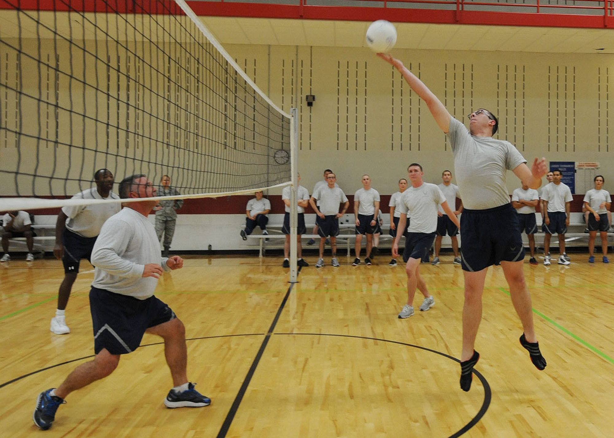 Senior Airman Christopher Orr, 28th Aircraft Maintenance Squadron electrical and environmental technician, sets the ball during a volleyball game in the Bellamy Fitness Center at Ellsworth Air Force Base, S.D., Sept. 17, 2013. After five weeks of Airman Leadership School, instructors held a celebratory volleyball game pitting ALS students against base leadership. (U.S. Air Force photo by Airman 1st Class Rebecca Imwalle / Released)